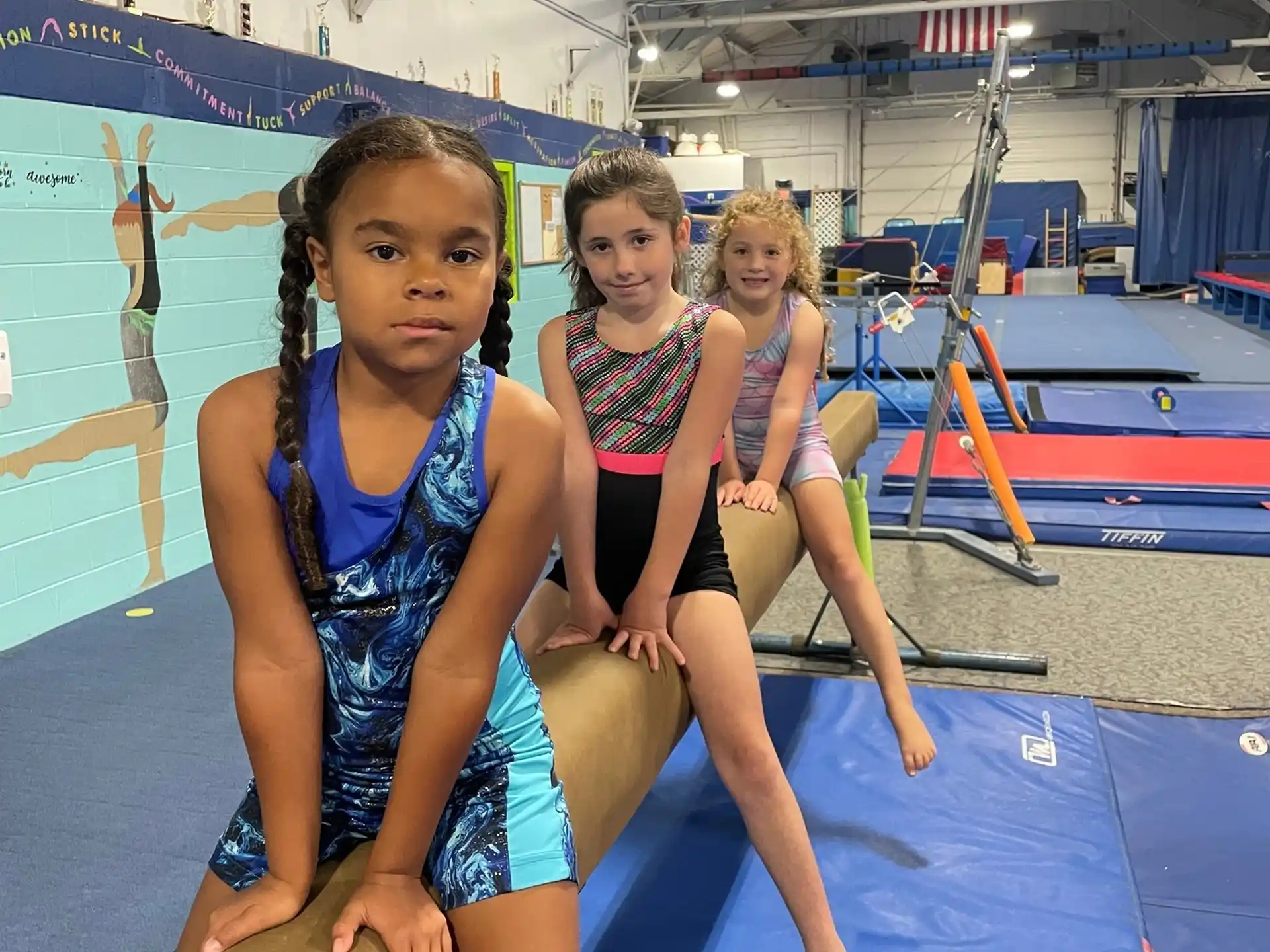 a group of girls in swimsuits in a swimming pool