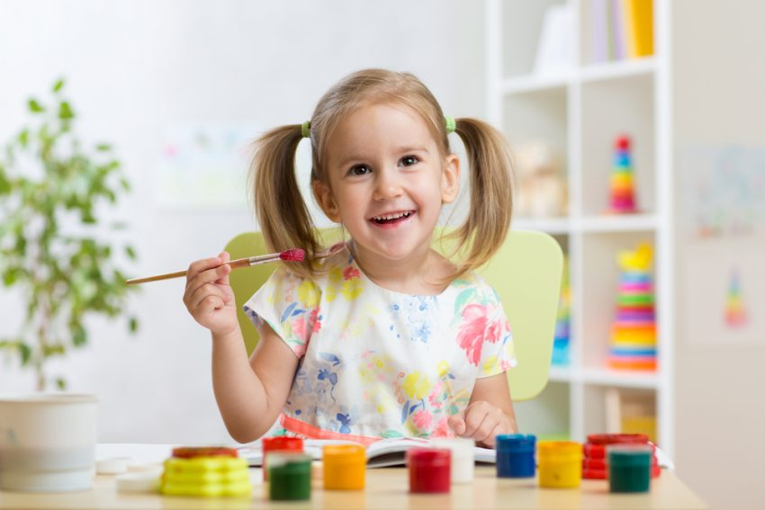 a girl painting with a brush