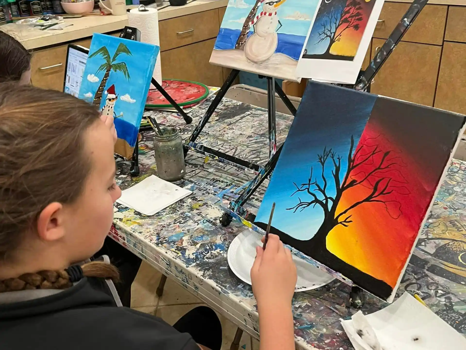 a boy painting on a table