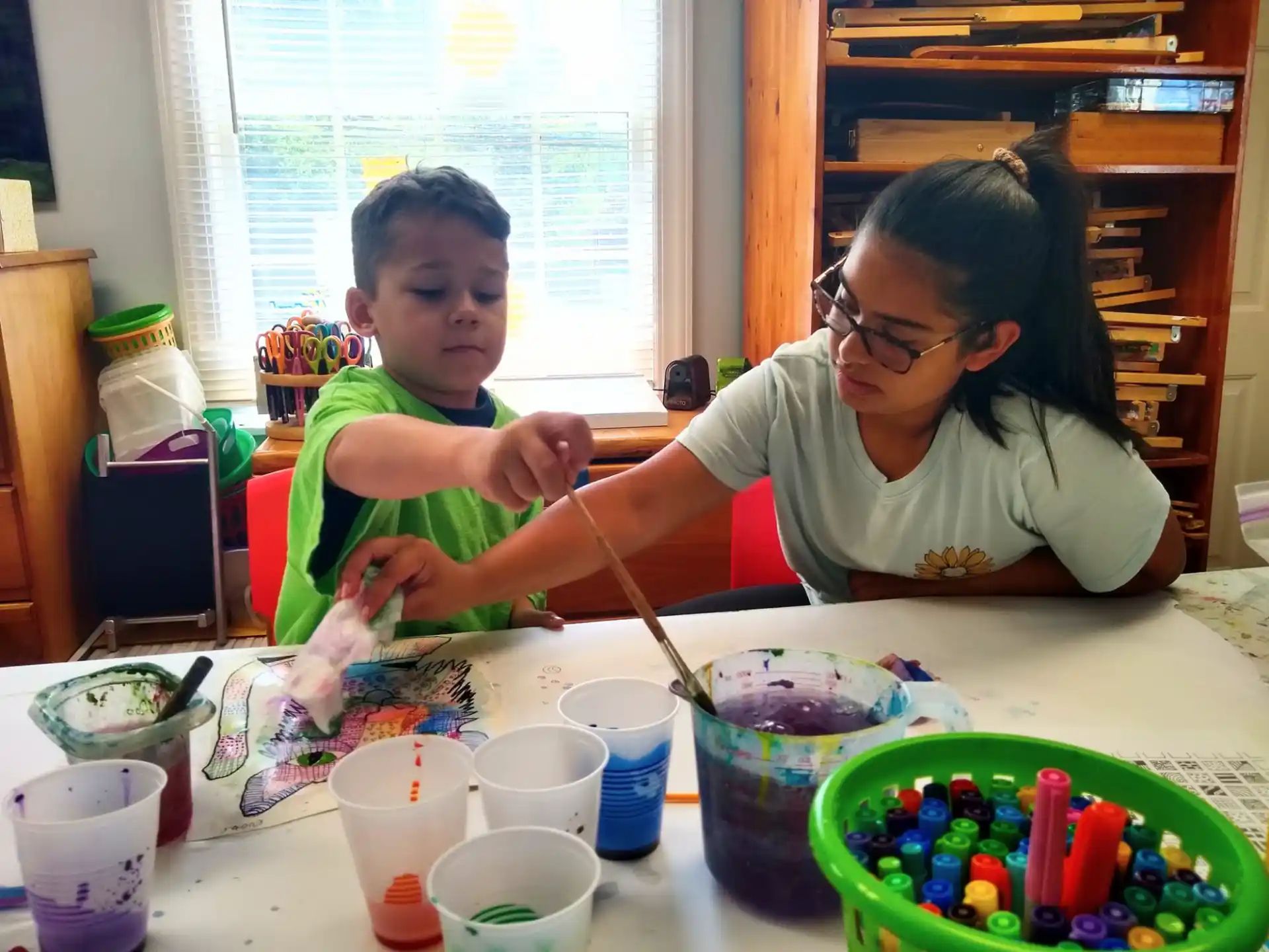 a person and a child painting
