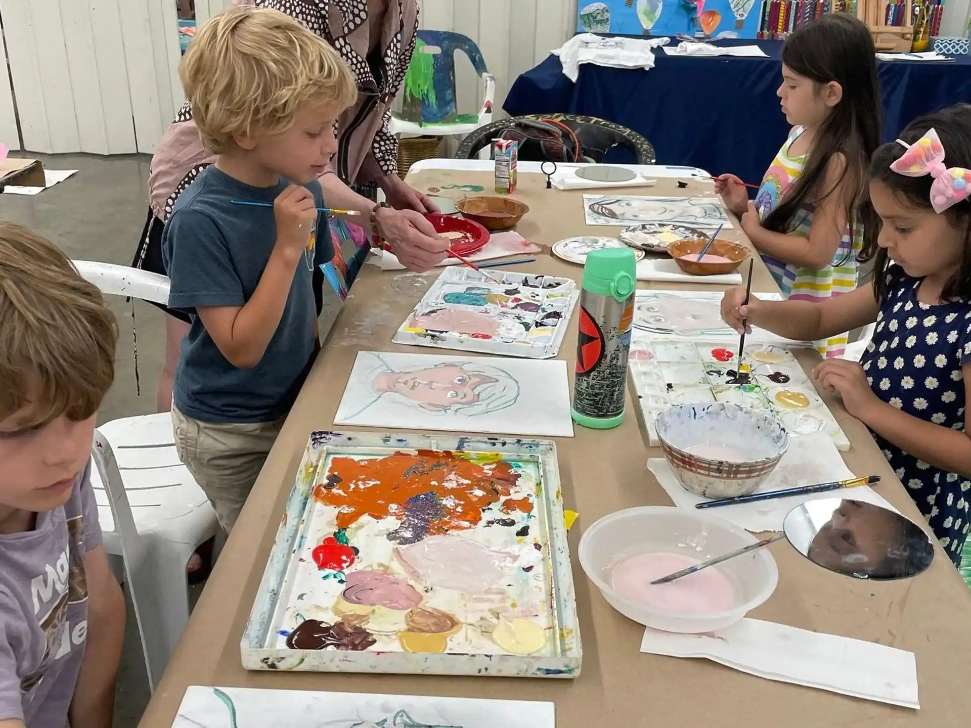 a person and a group of kids are eating cake