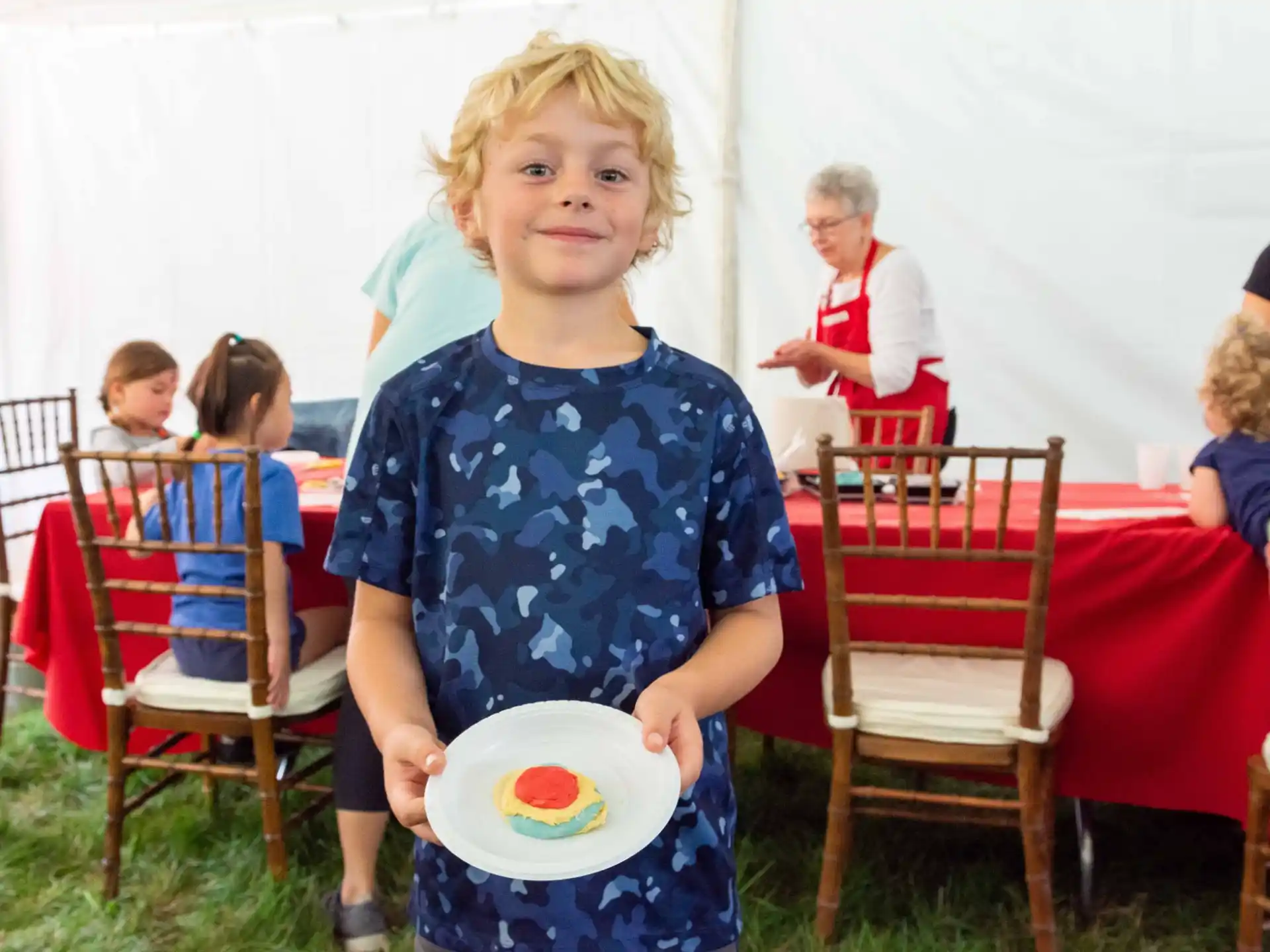 a boy holding a plate
