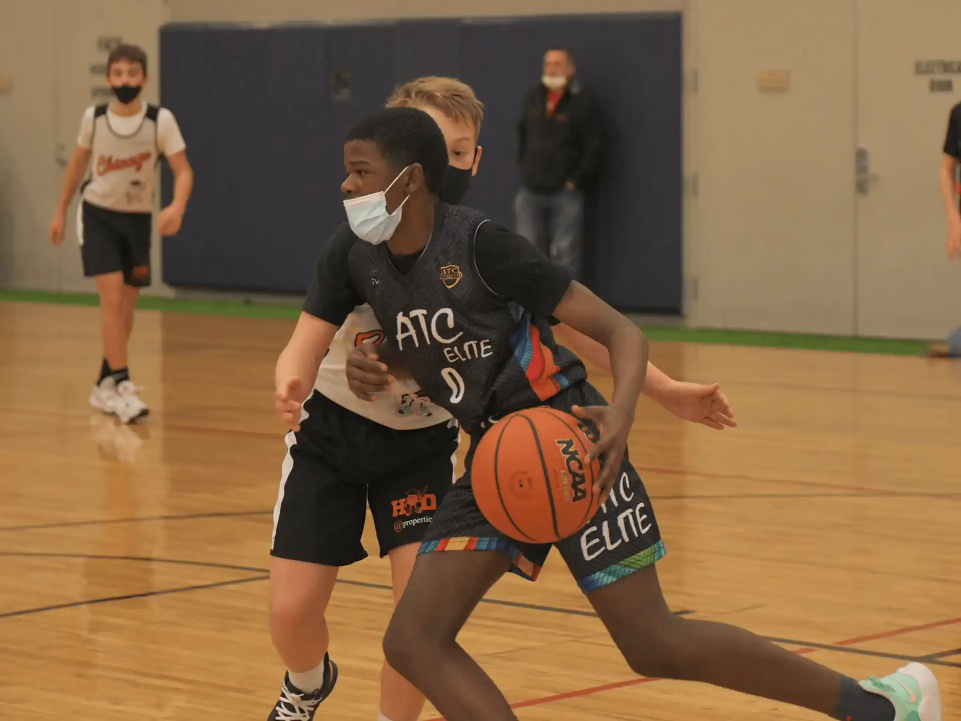 a couple of people playing basketball