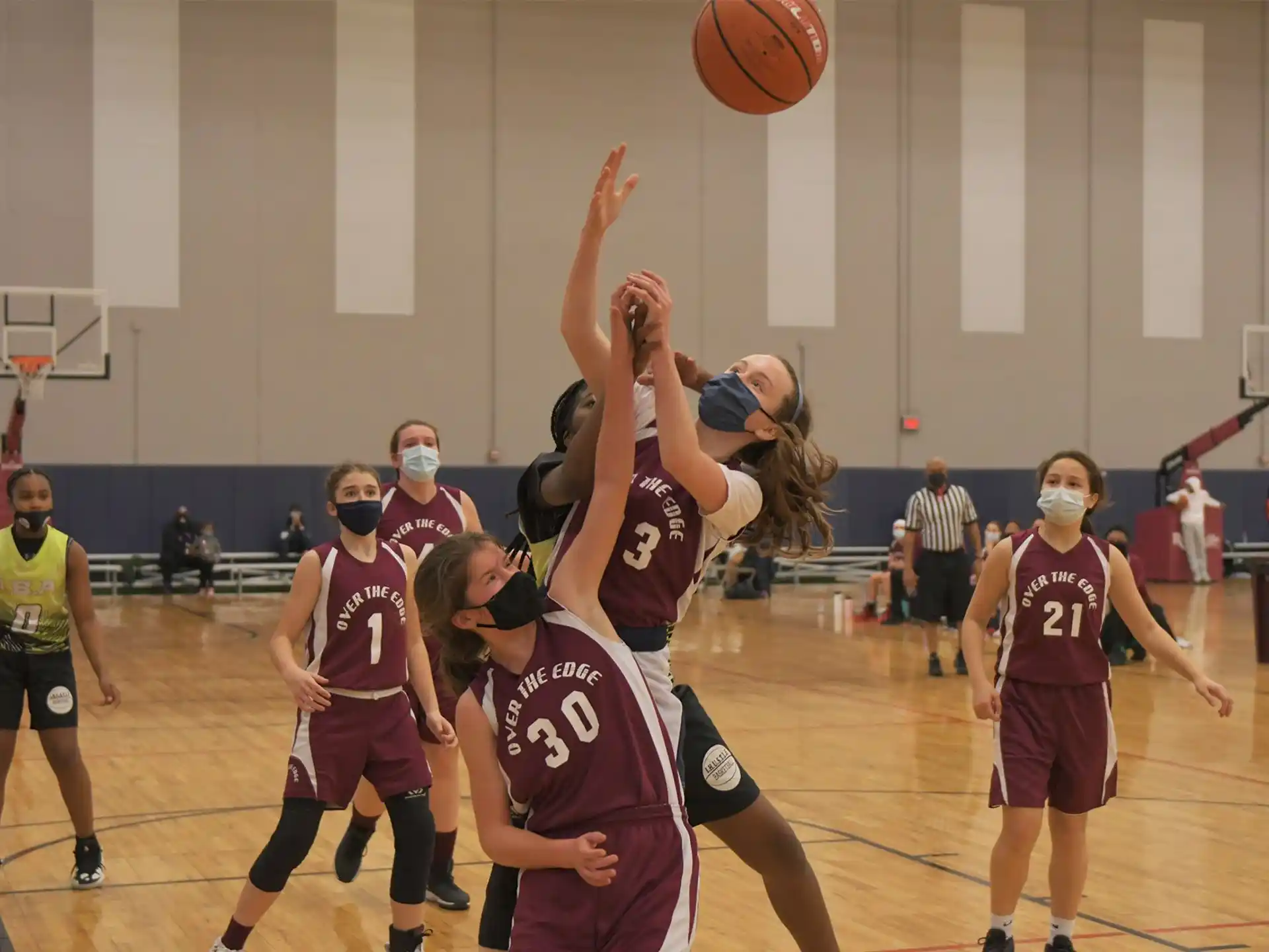 a group of people playing basketball