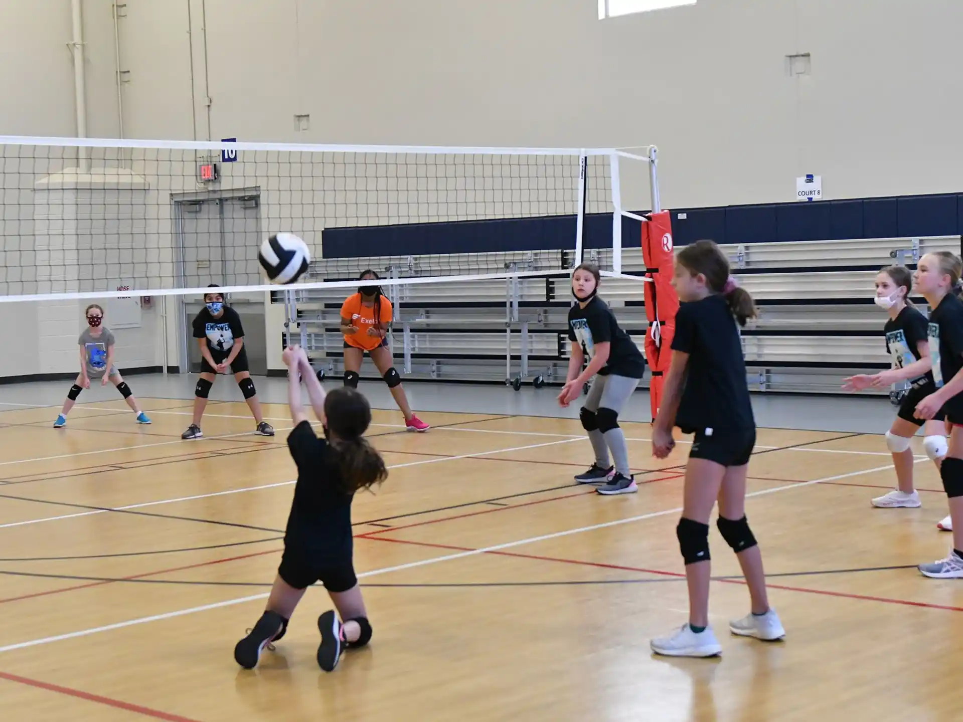 a group of people playing volleyball