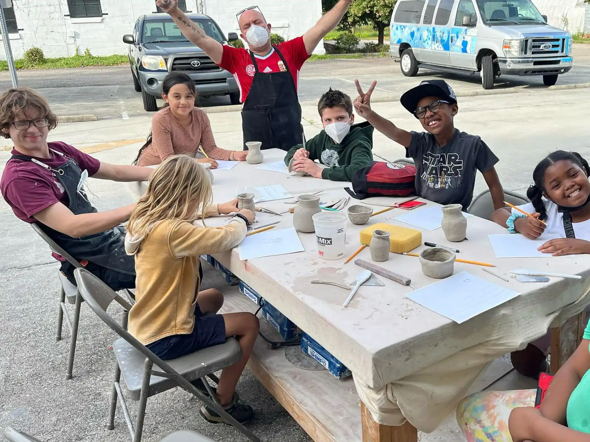 a group of people sitting around a table outside