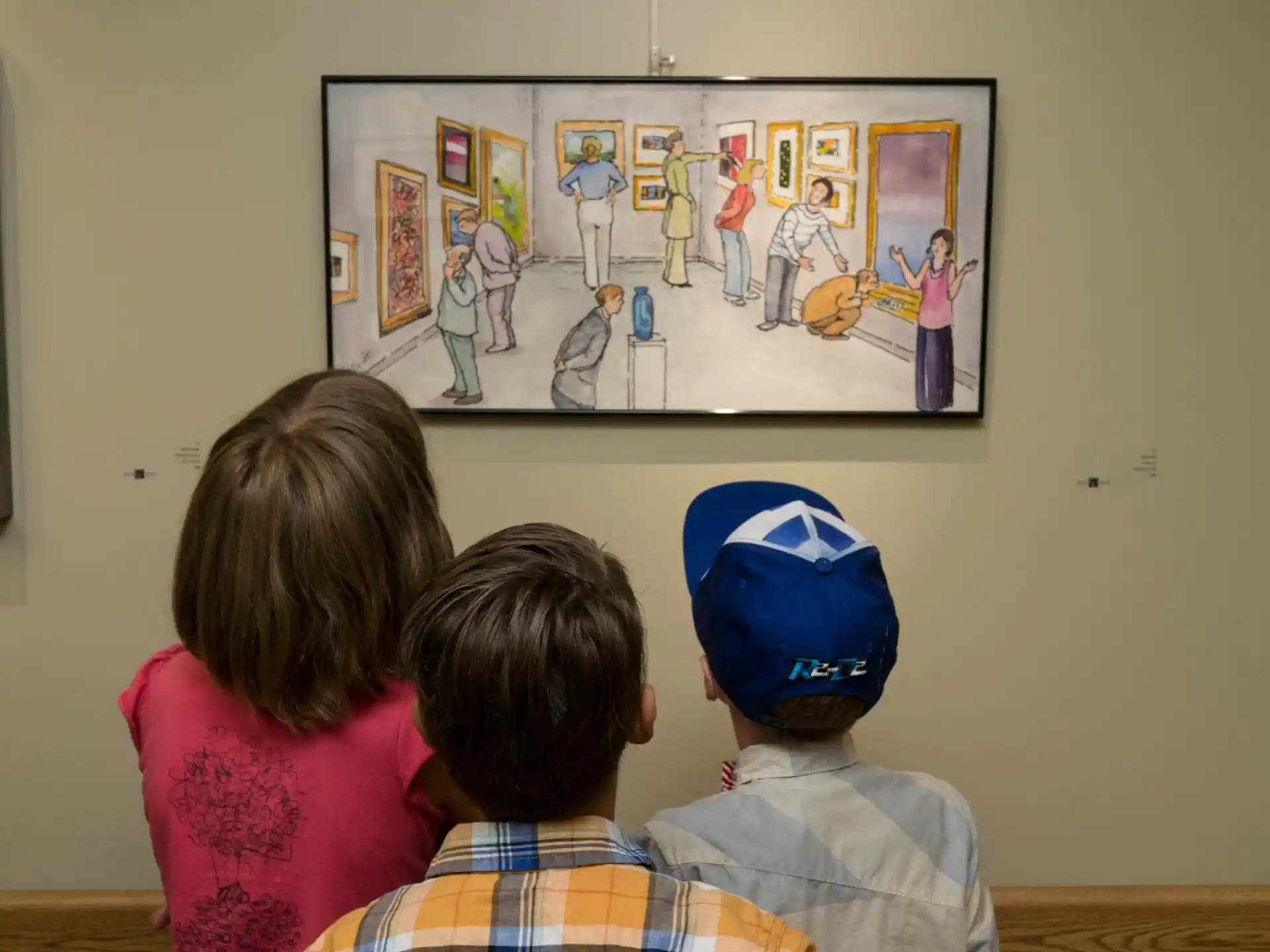 a group of children looking at a framed picture on a wall