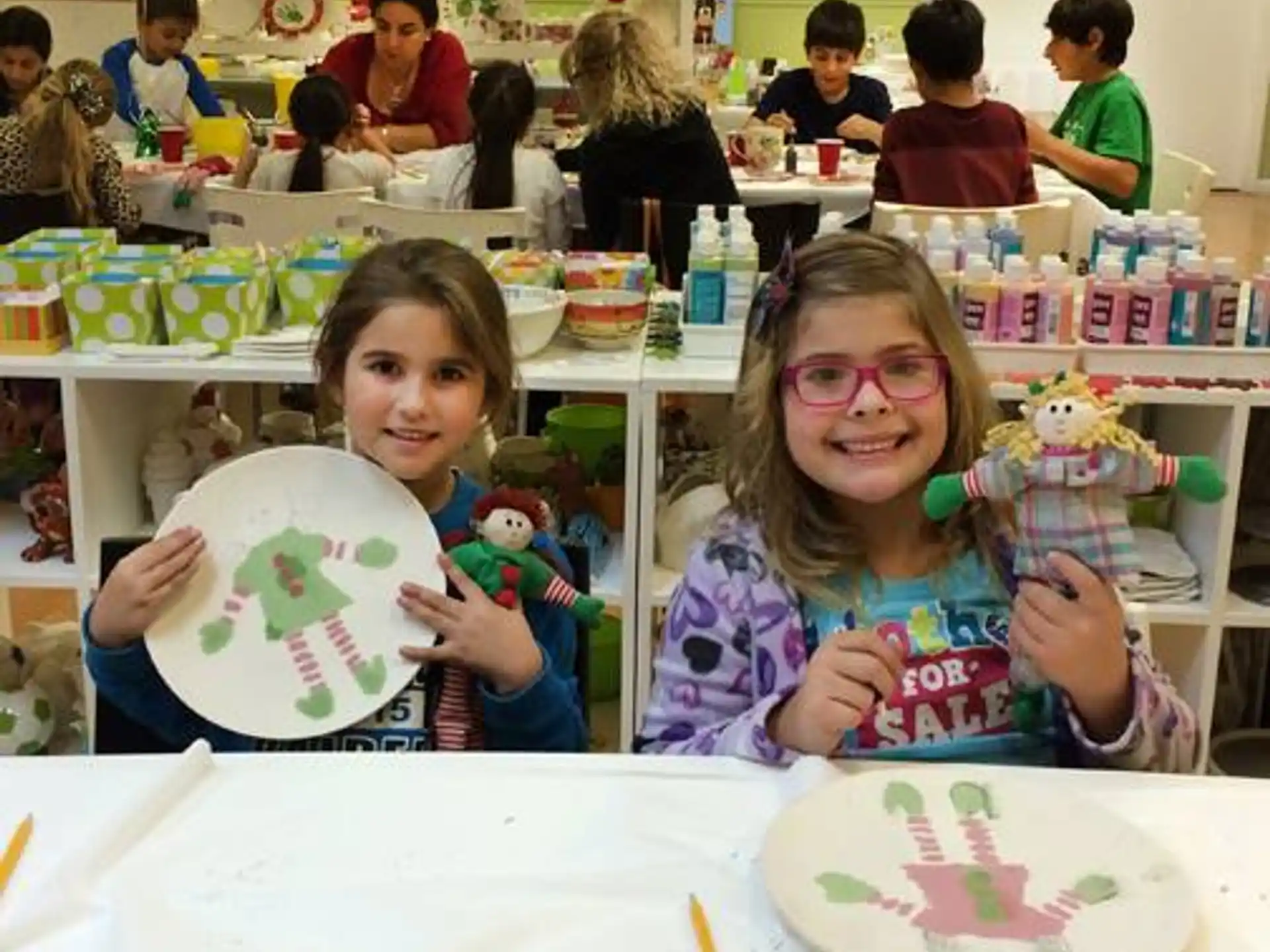 a couple of girls holding up a drawing