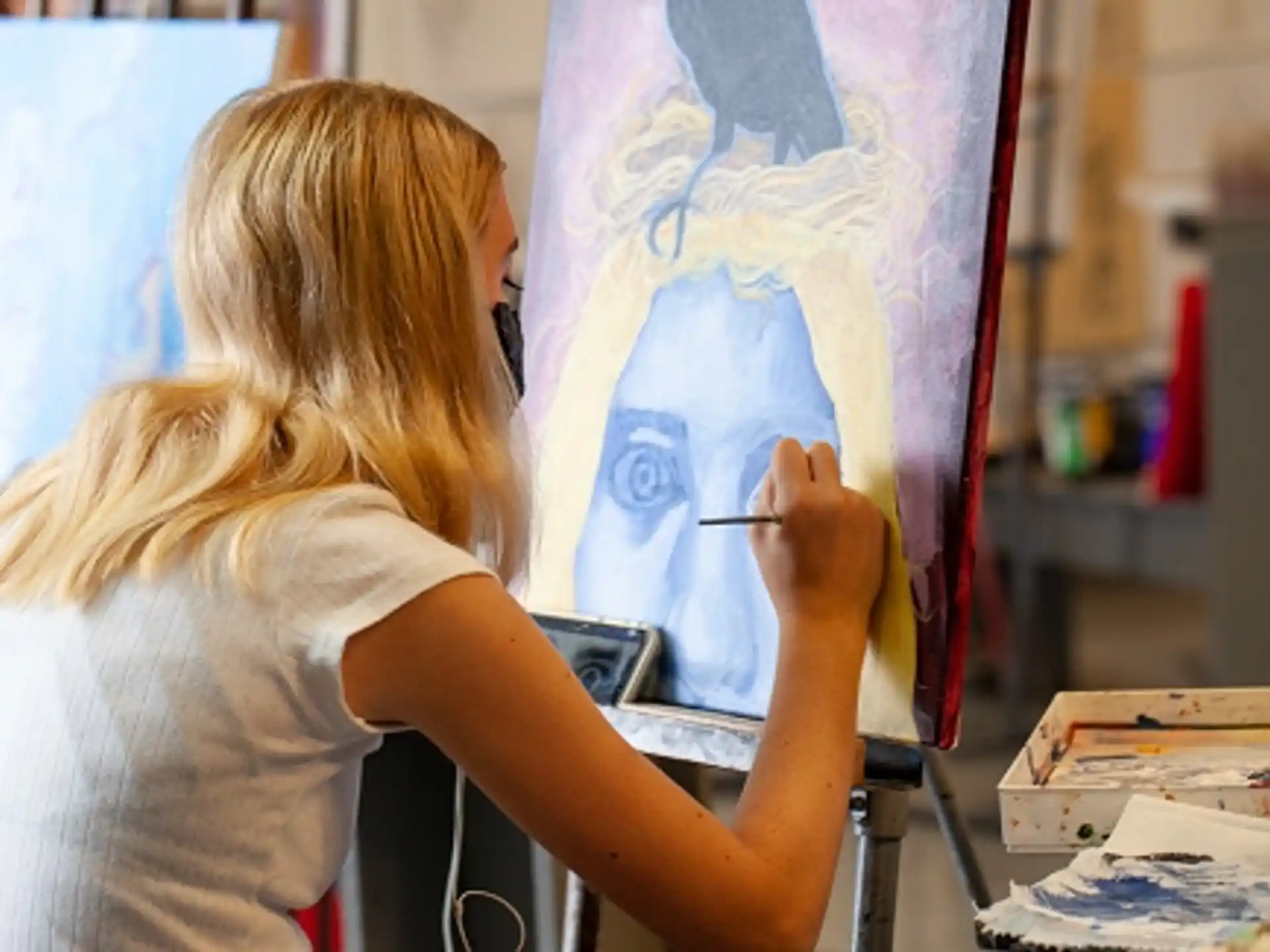 a woman painting a picture