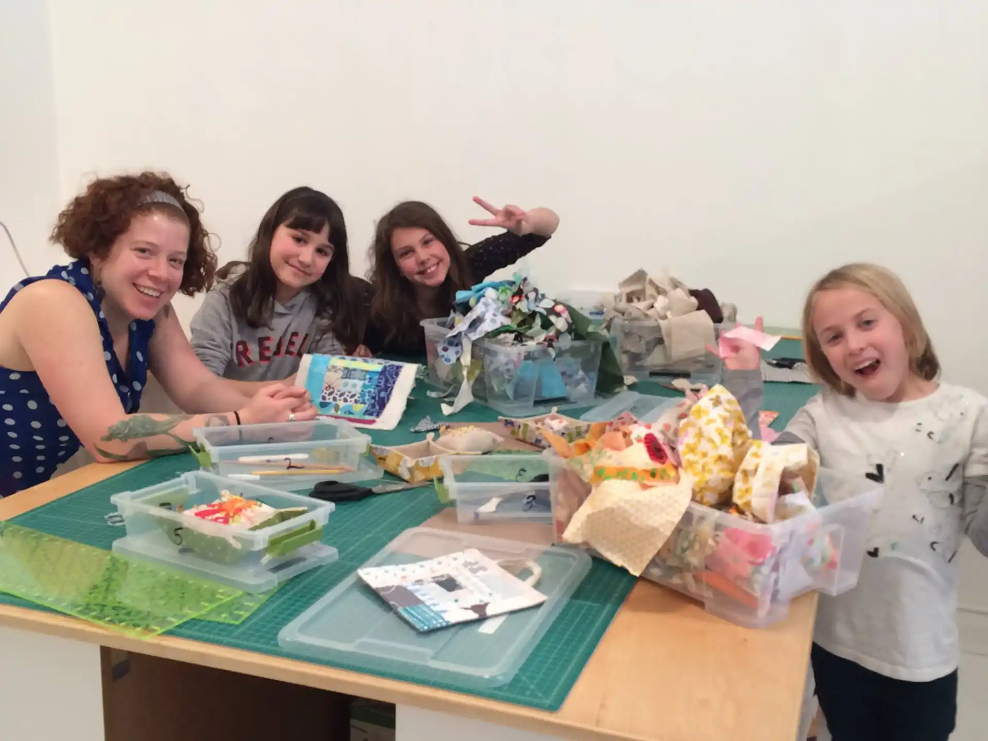 a group of women sitting at a table with food and drinks