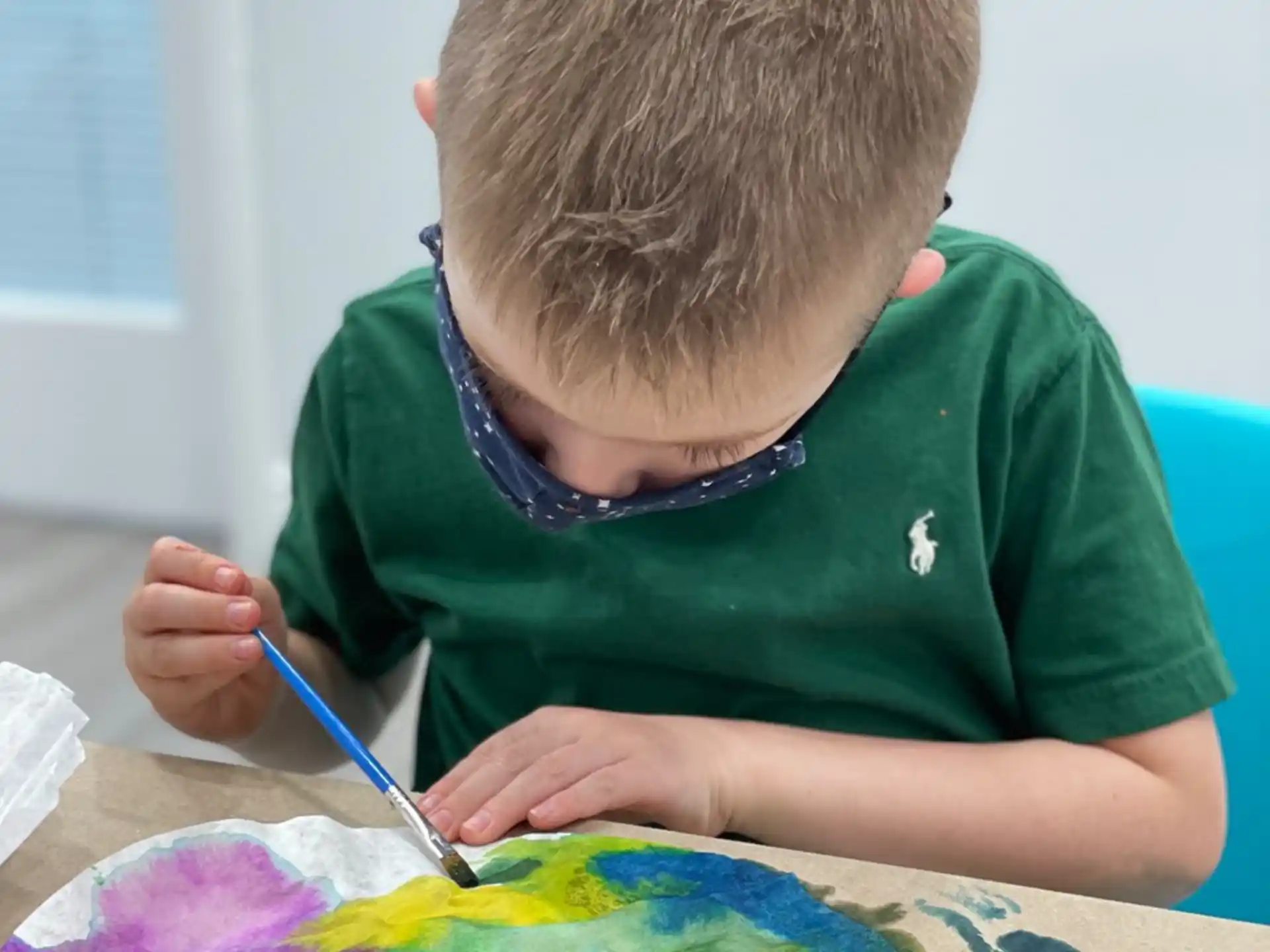 a boy painting on a table