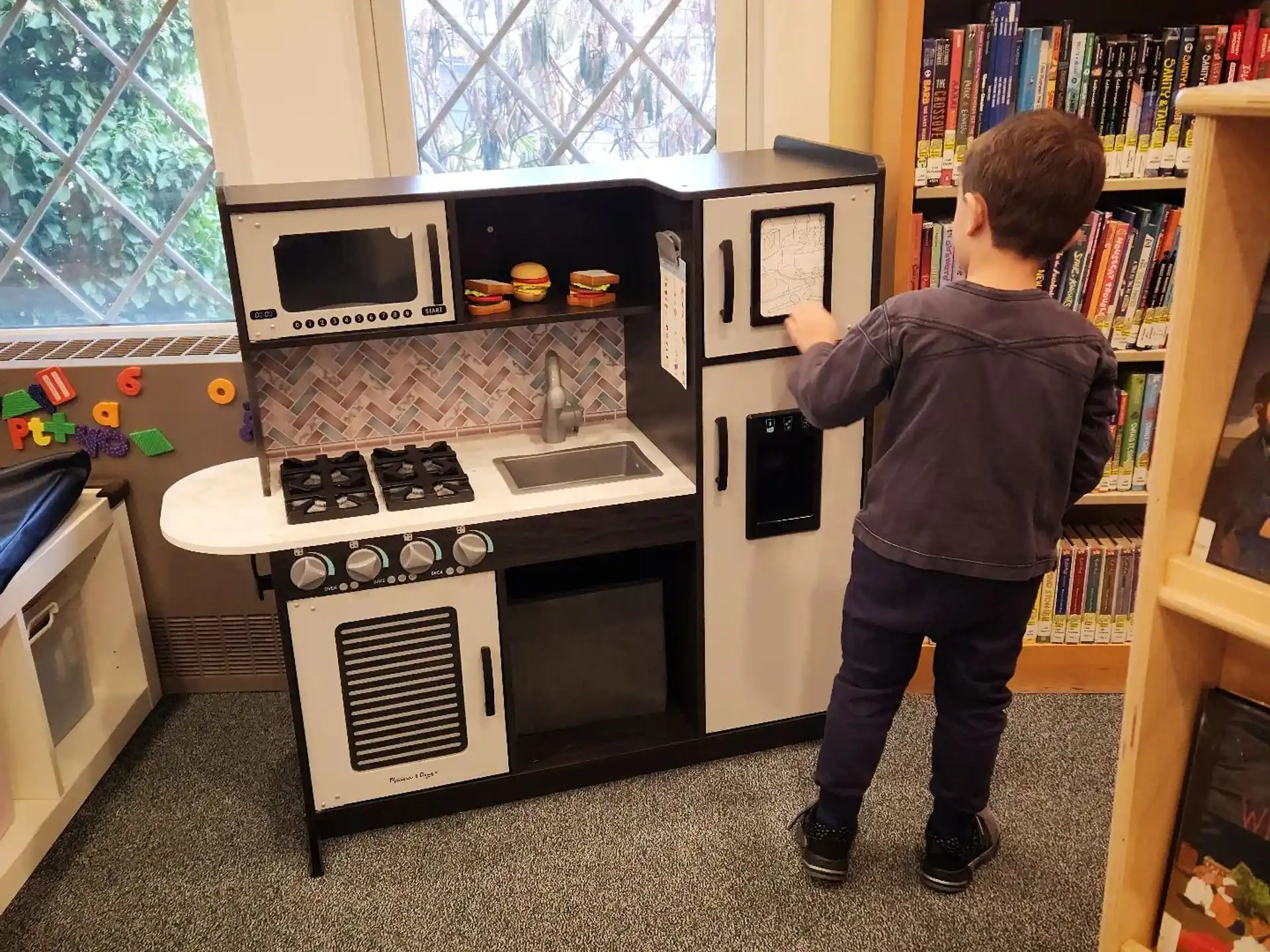 a boy standing next to a machine