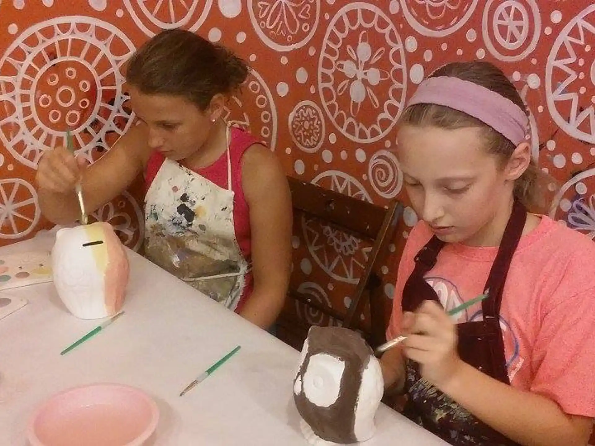 a couple of girls eating at a table