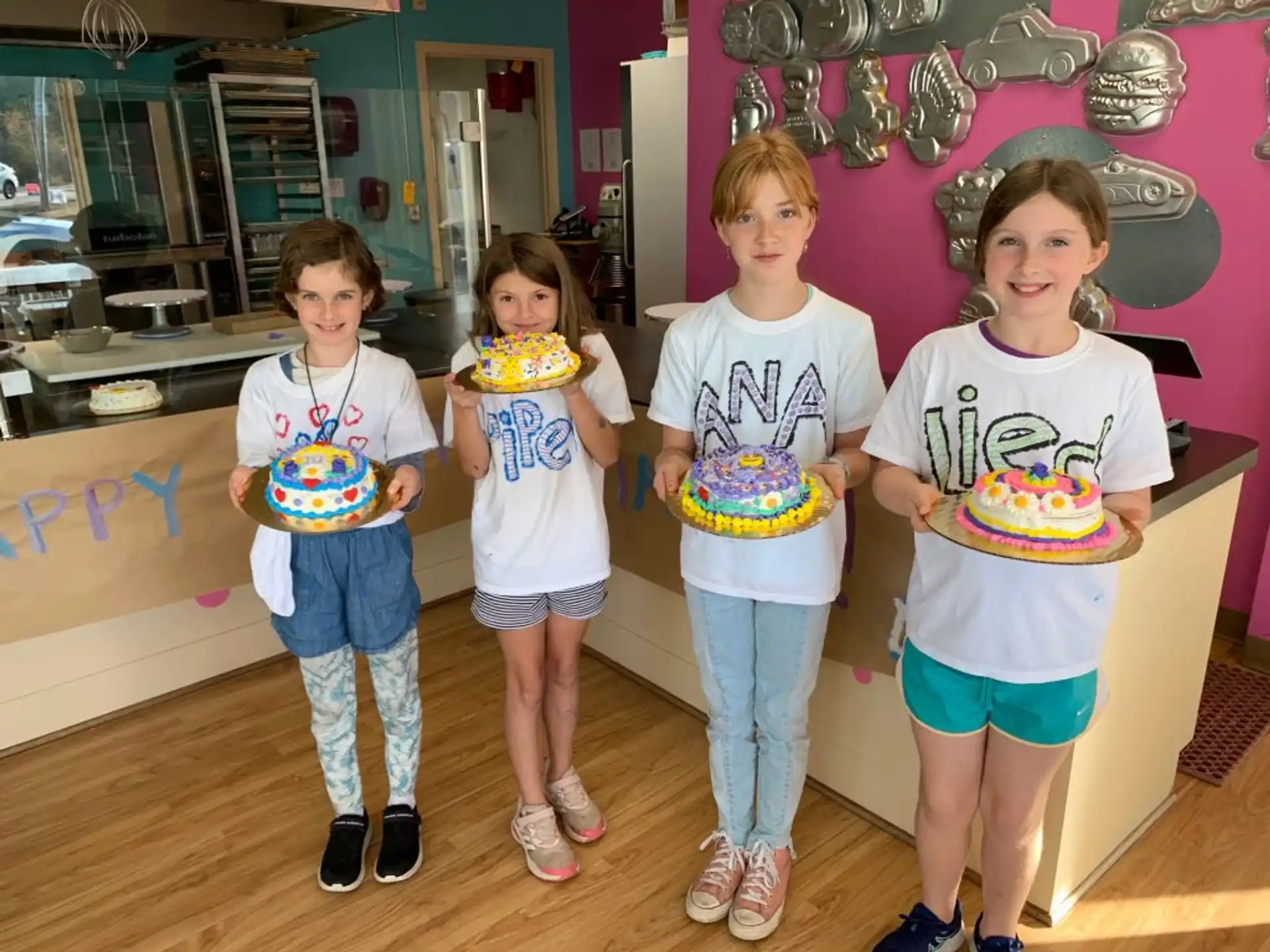 a group of children holding cake