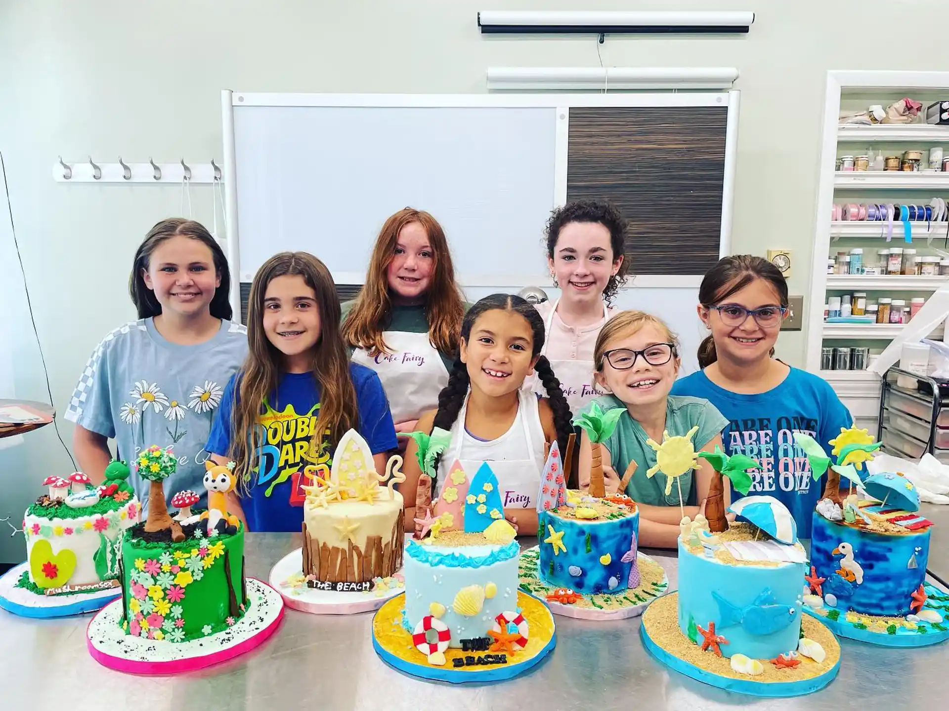 a group of people posing for a photo with cakes