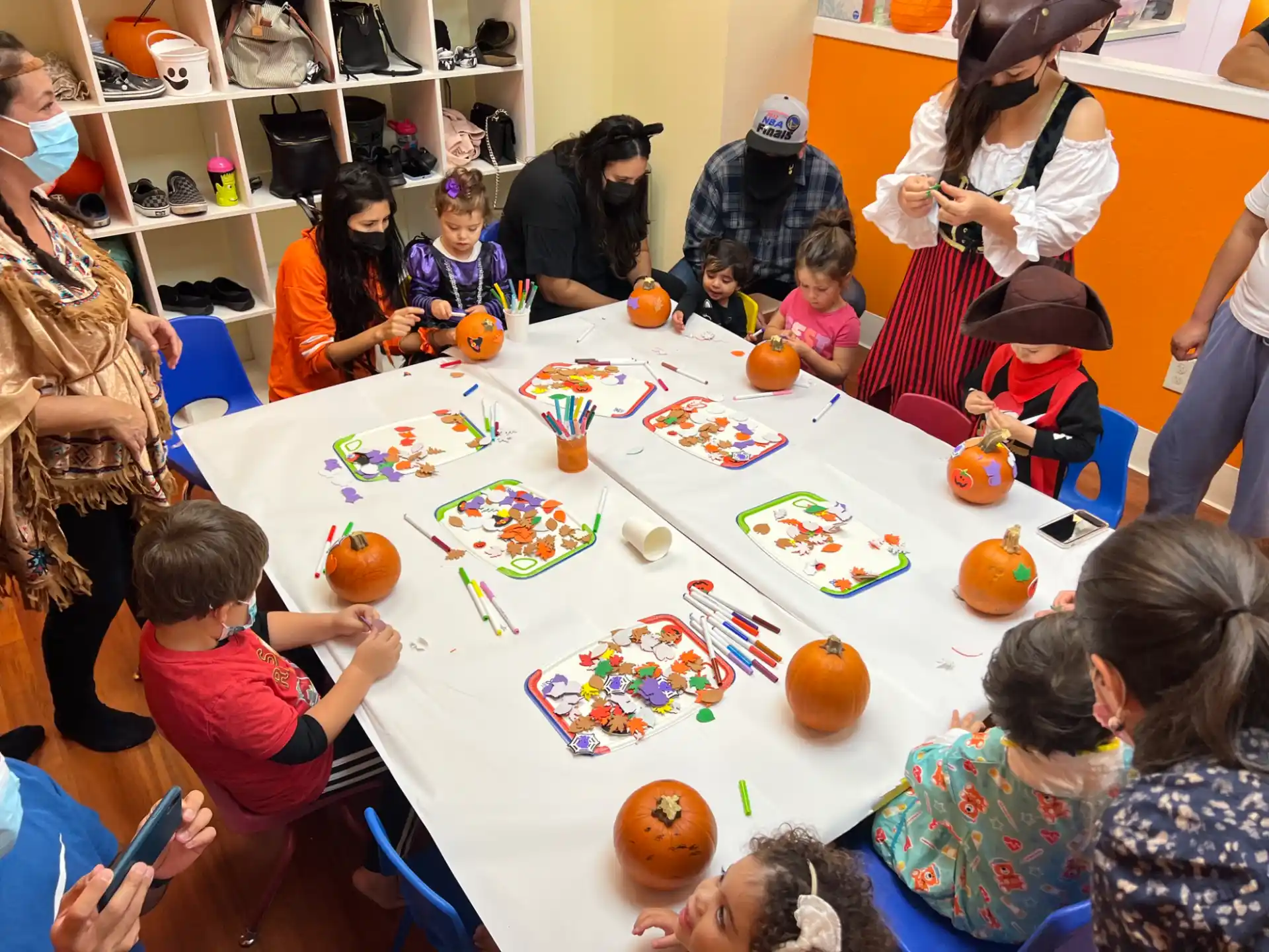 a group of people gather around a table