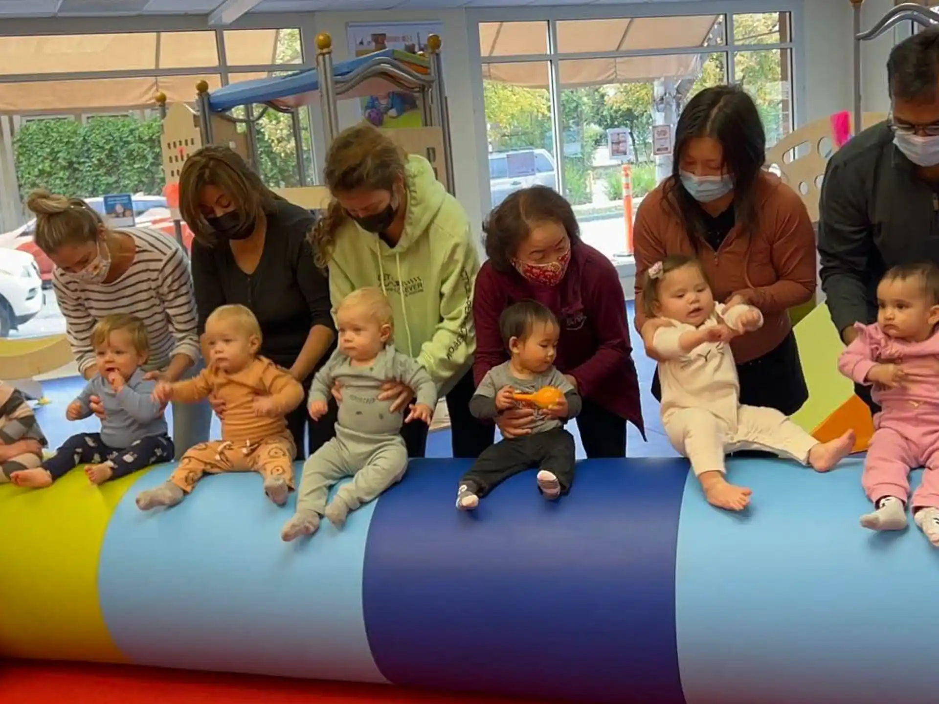a group of people sitting on a blue mat
