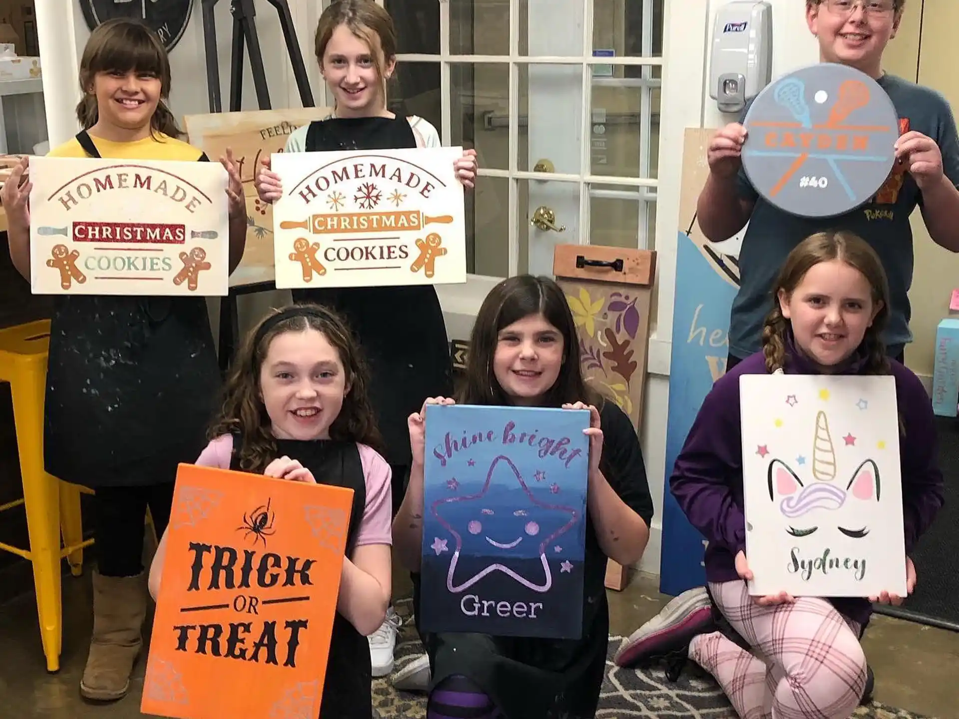 a group of kids holding signs