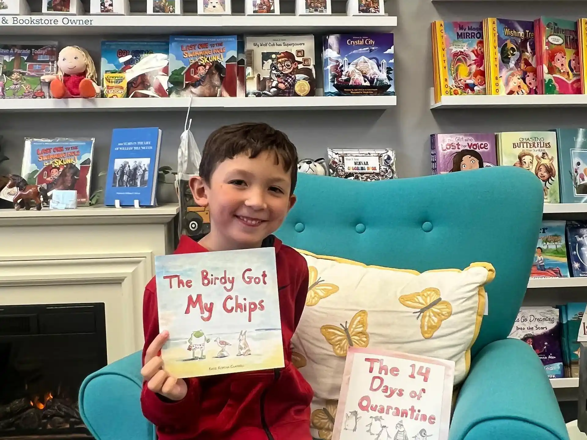 a boy sitting in a chair holding a sign