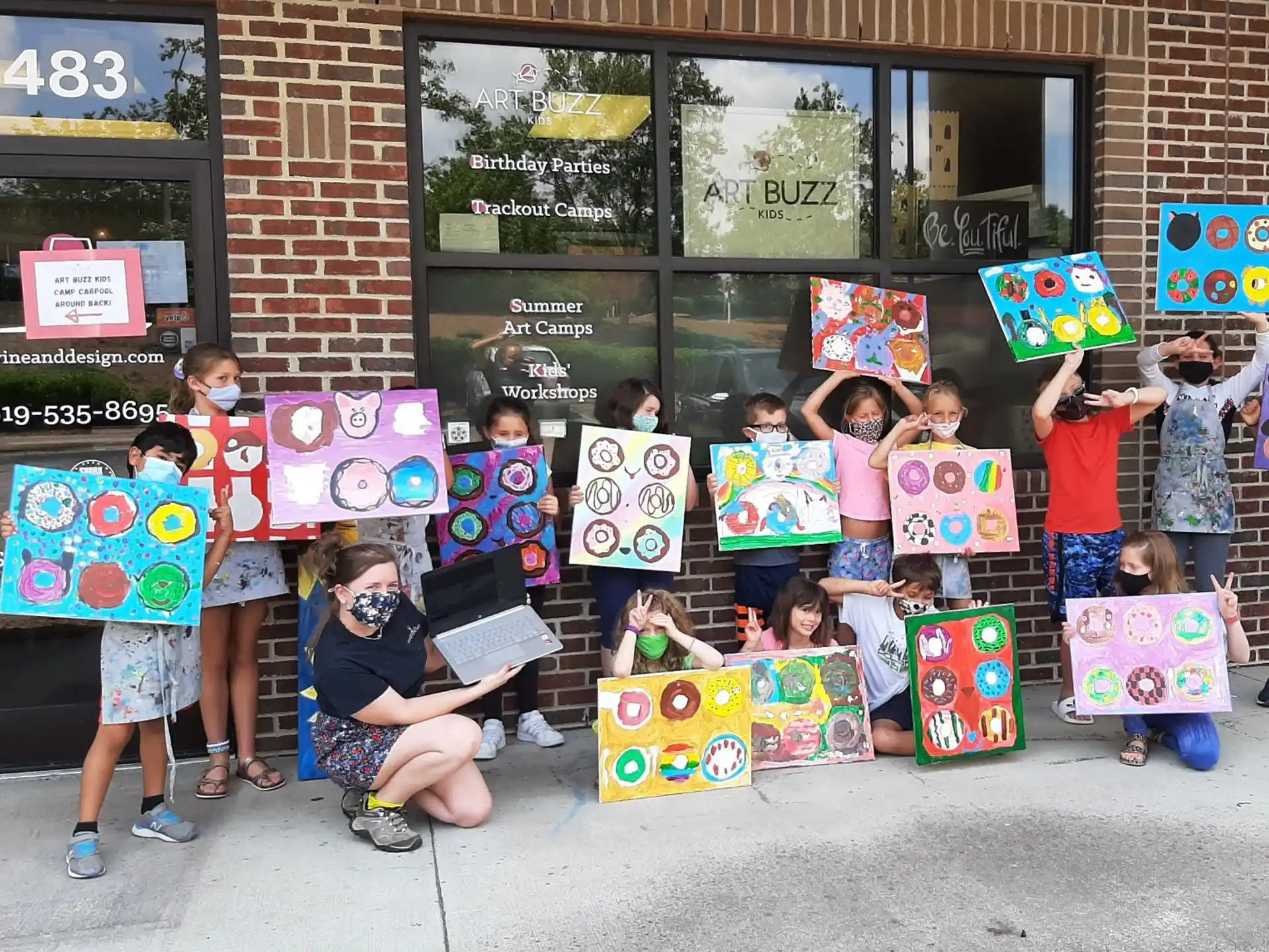 a group of children holding up colorful boxes