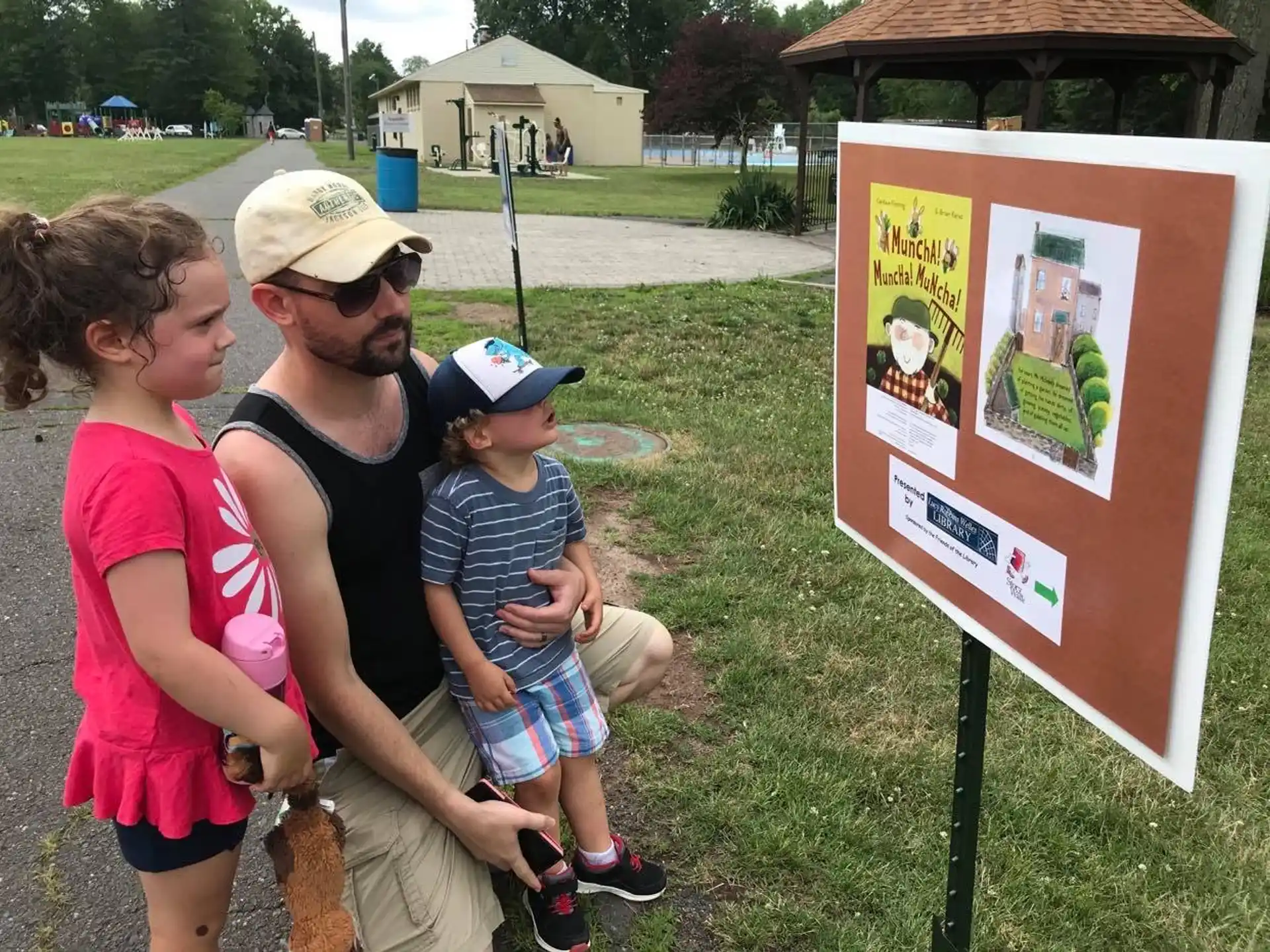 a man and woman looking at a sign