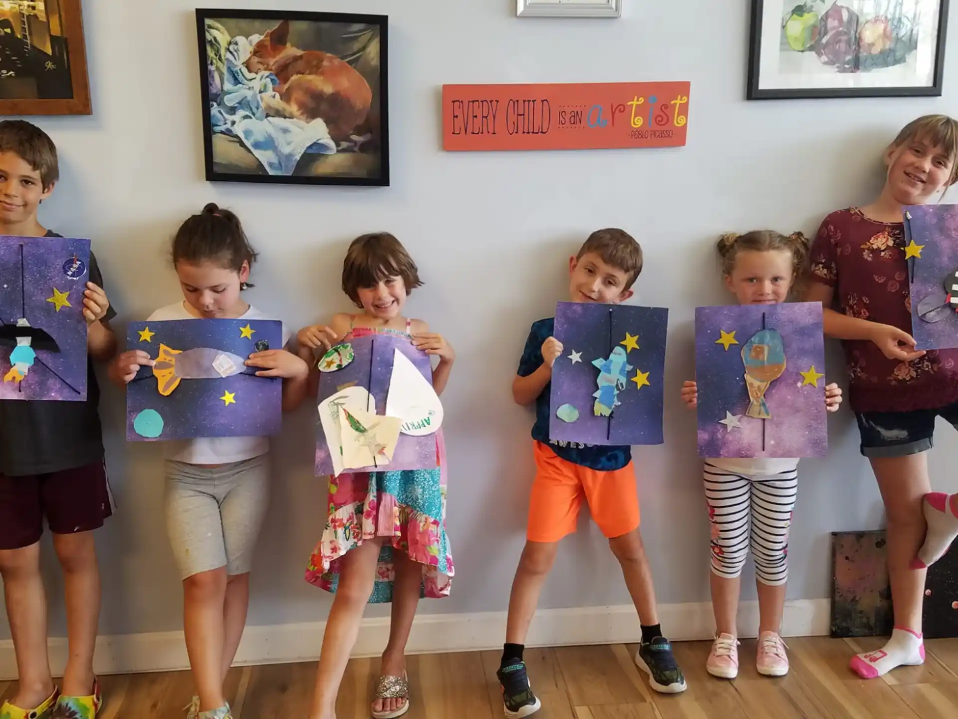 a group of children holding up posters