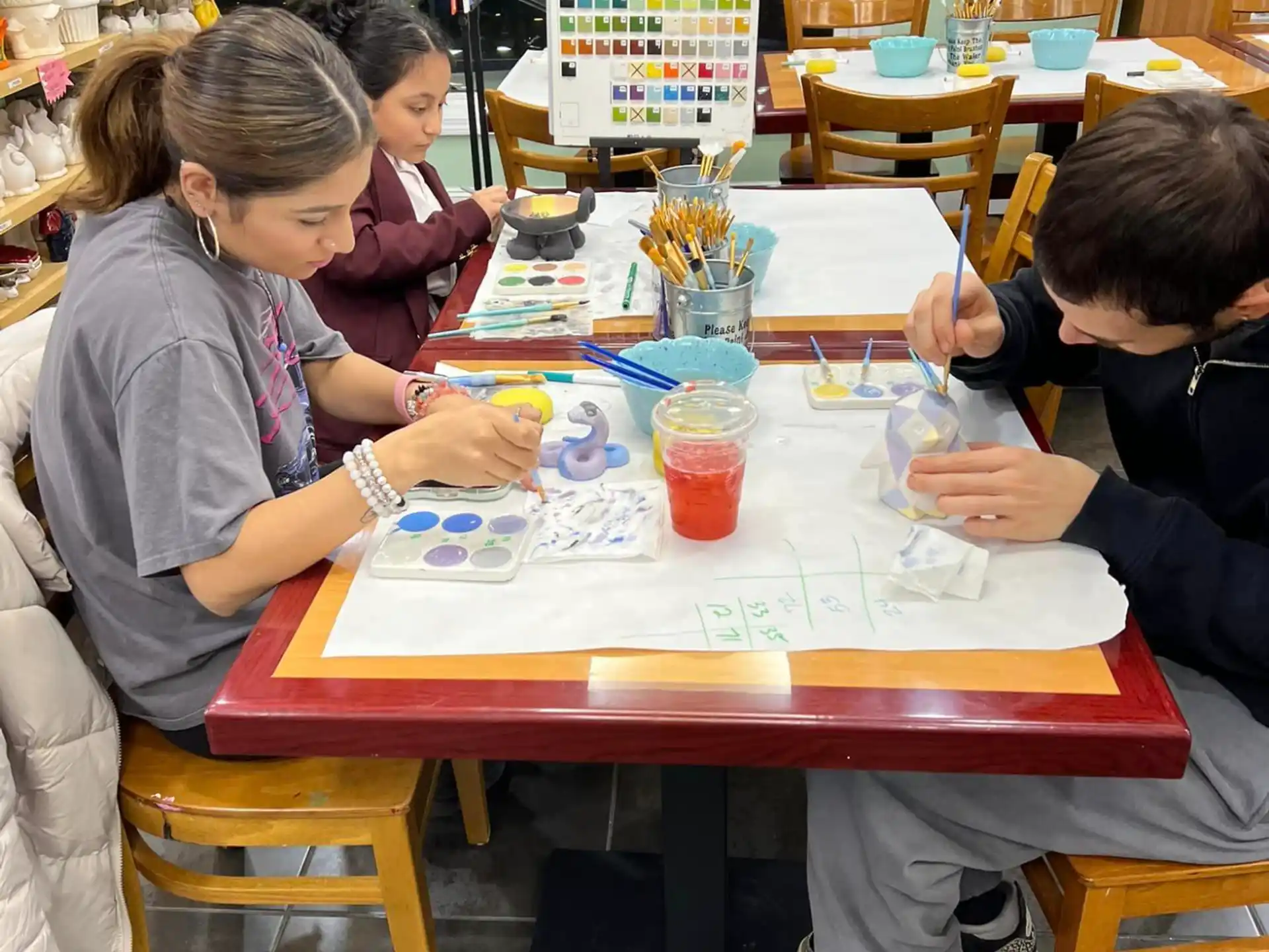 a group of children sitting at a table playing a board game