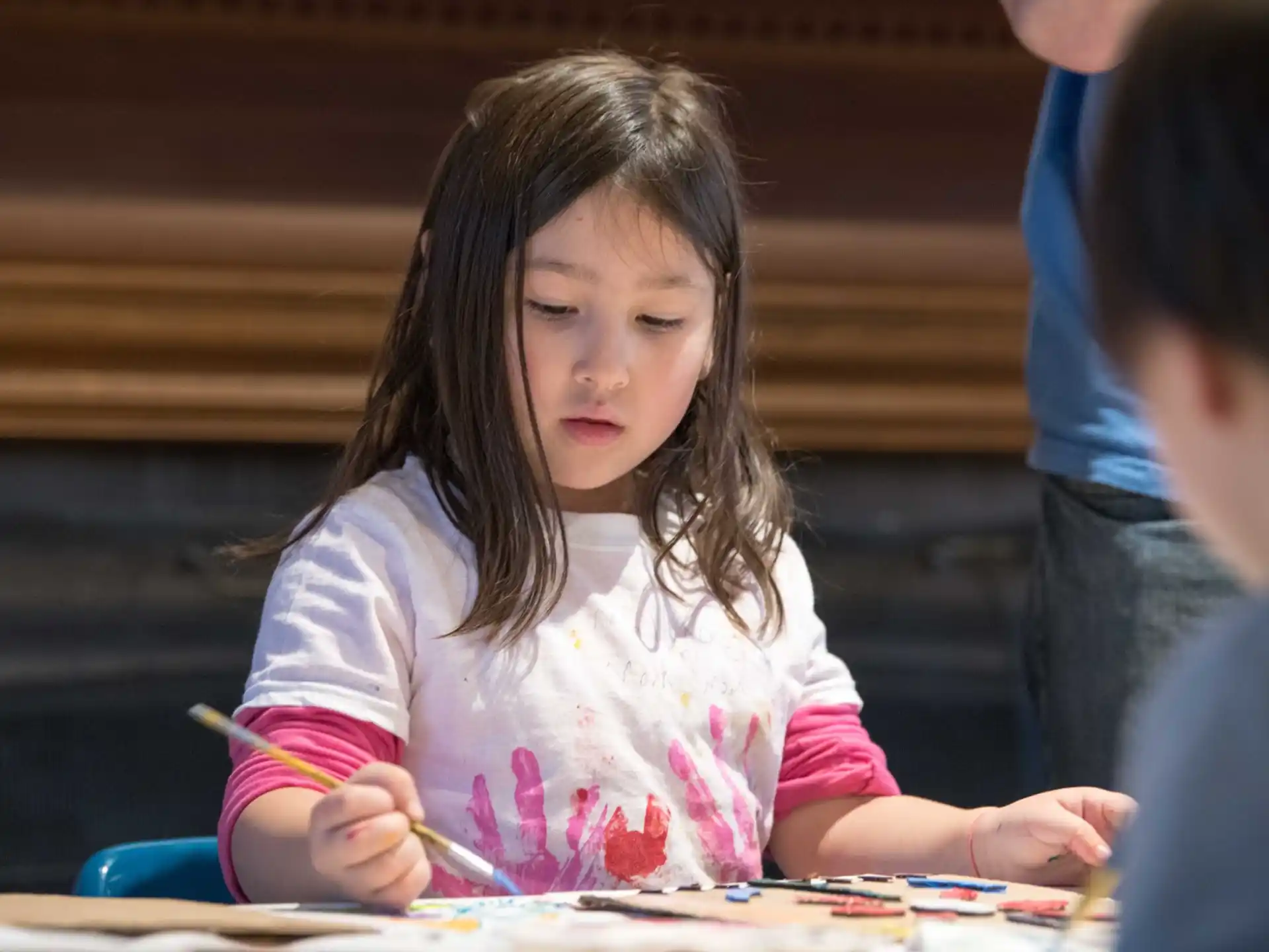 a young girl coloring on paper