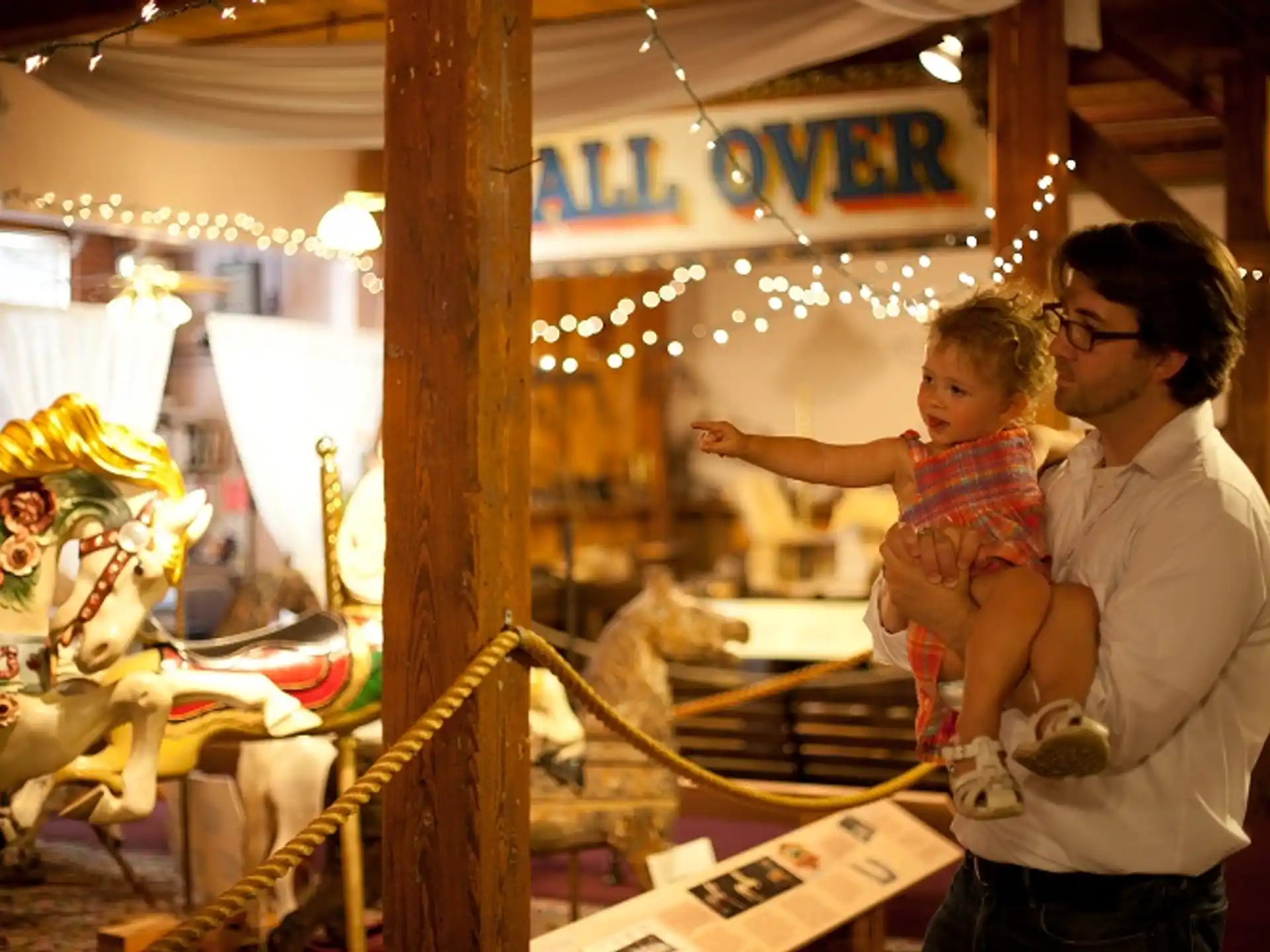a person and a child playing on a carousel