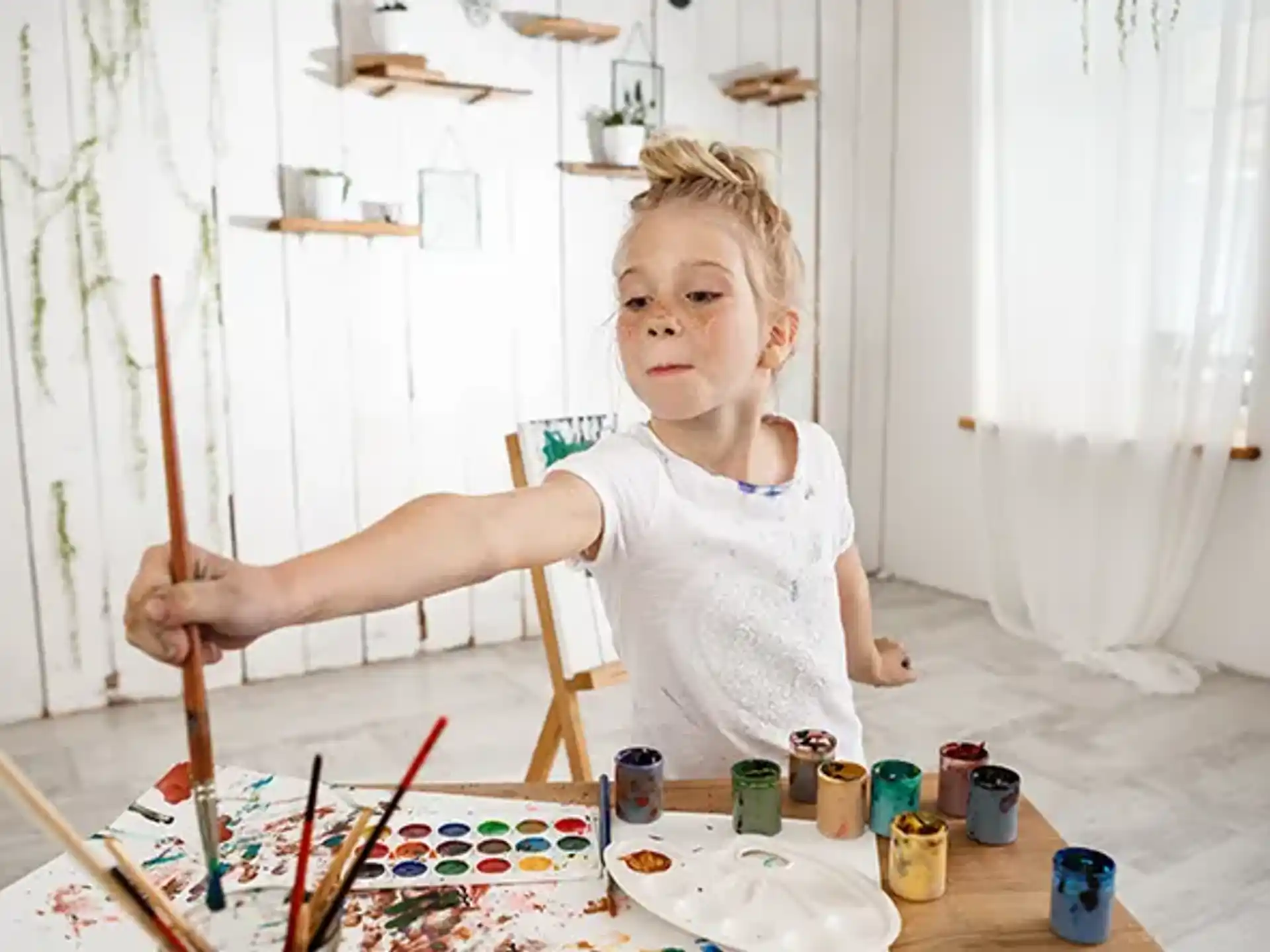 a girl painting on a table