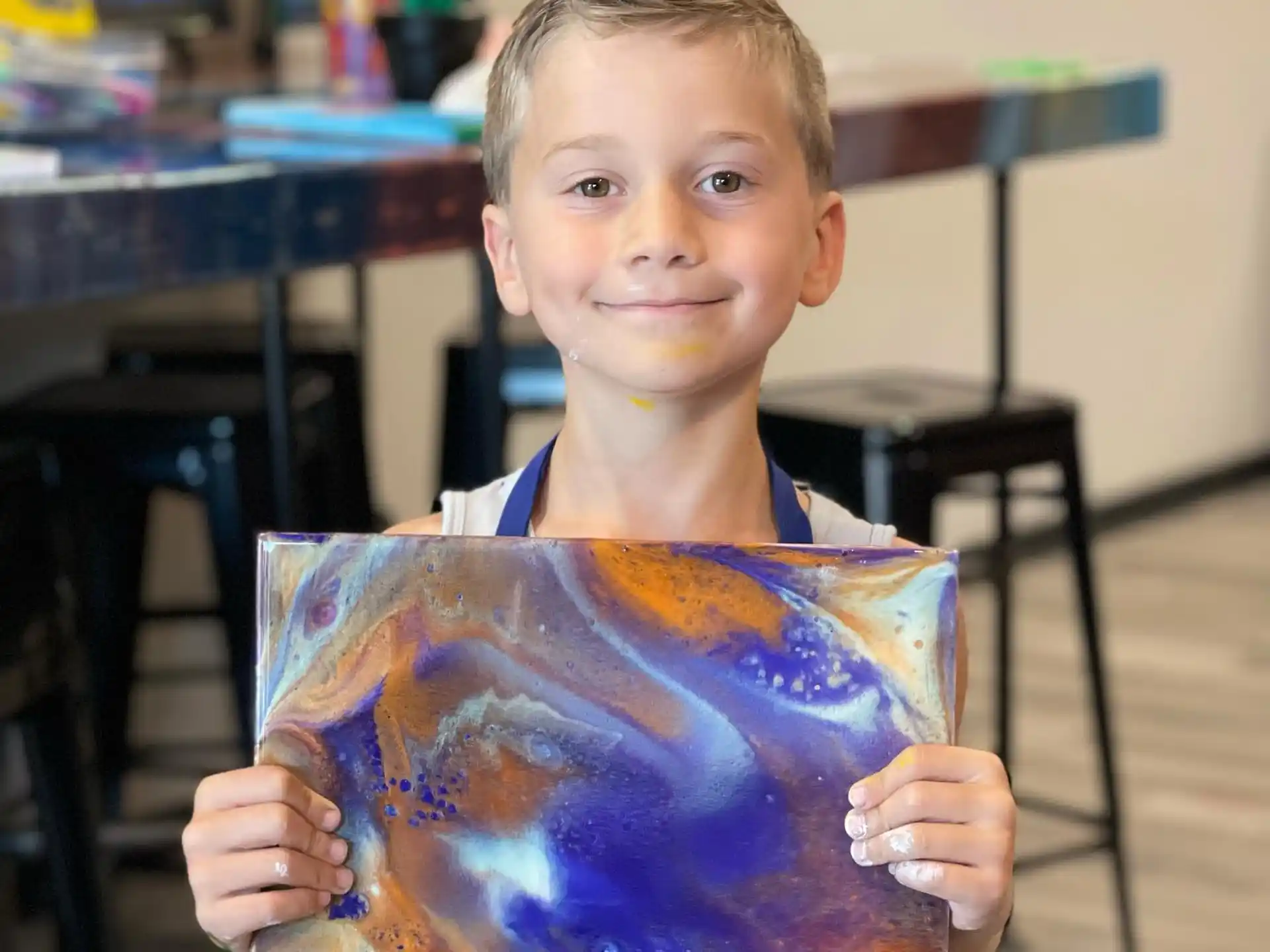 a boy holding a painting