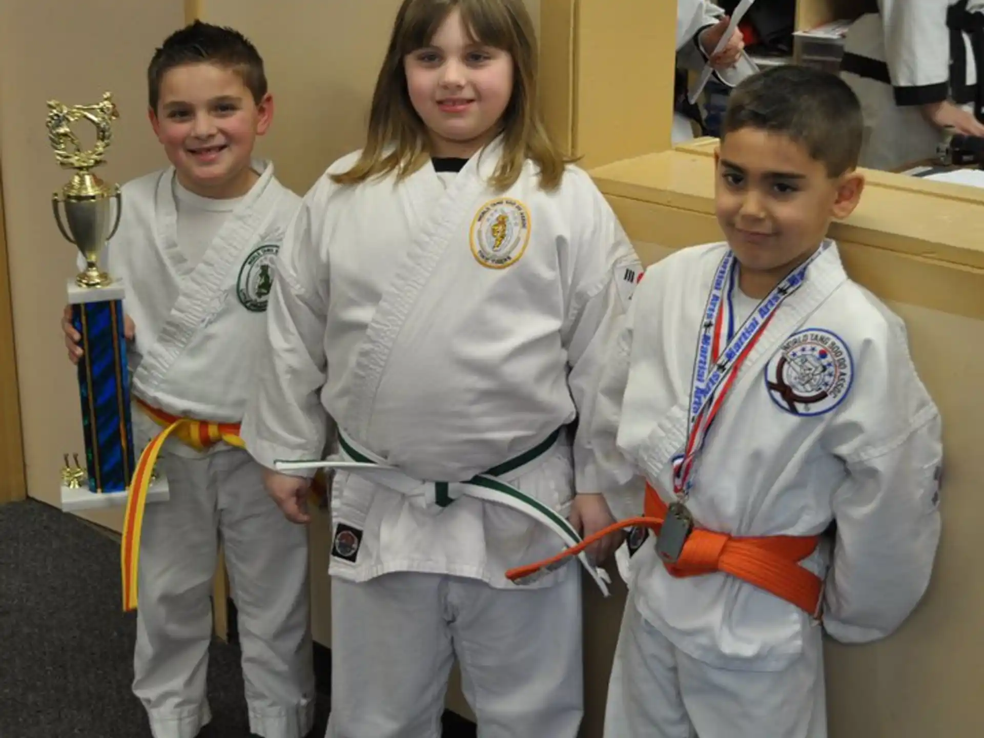 a group of children in karate uniforms