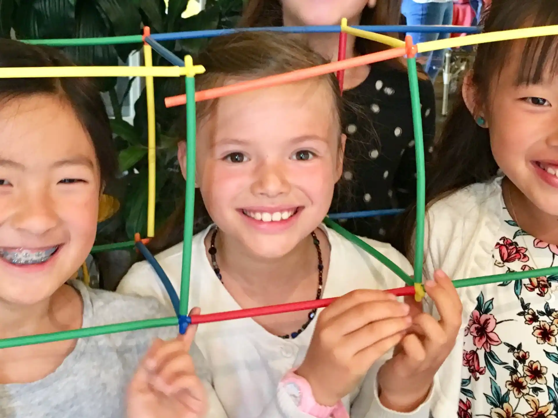 a group of girls holding colorful sticks