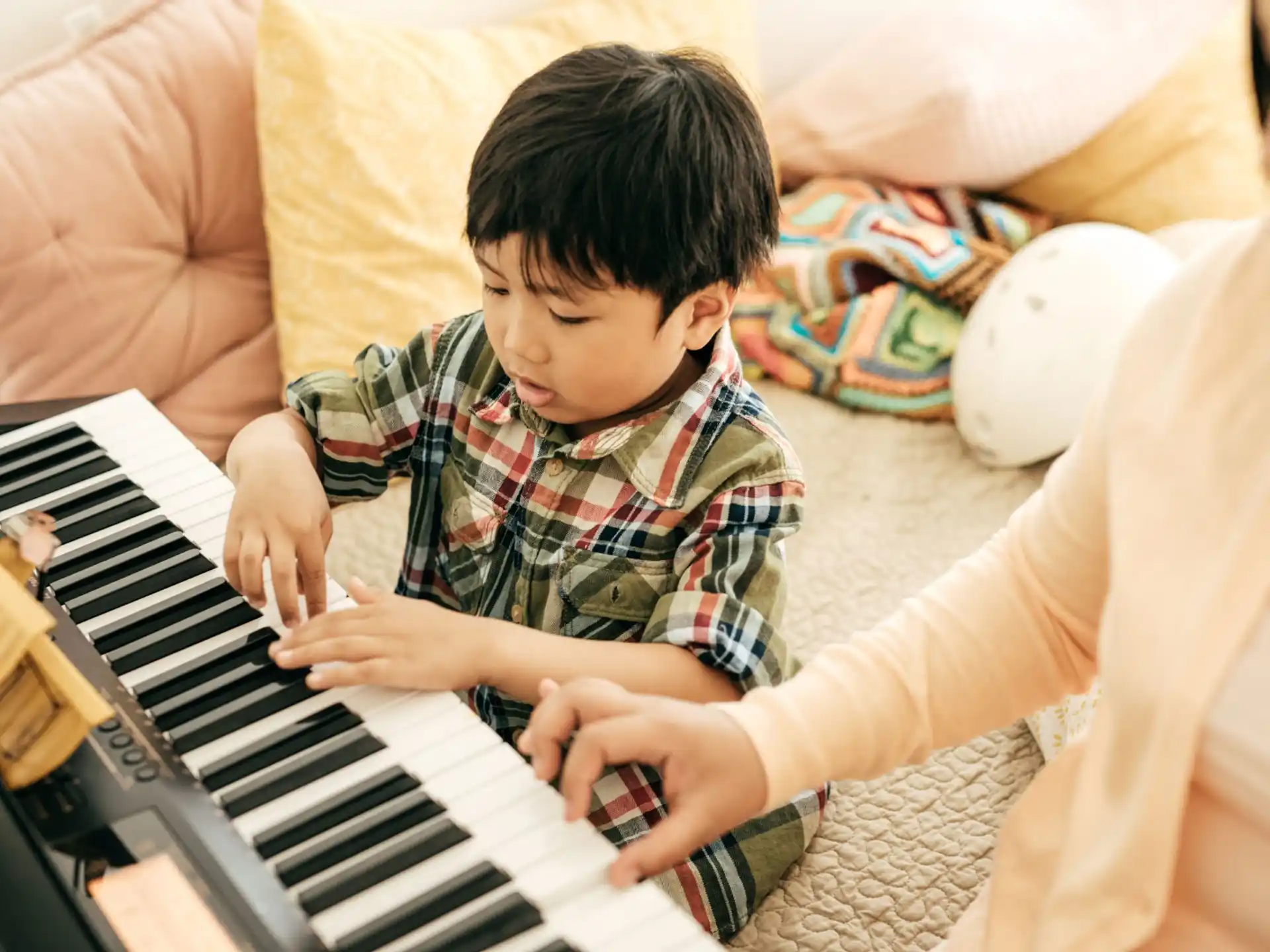 a boy playing a piano