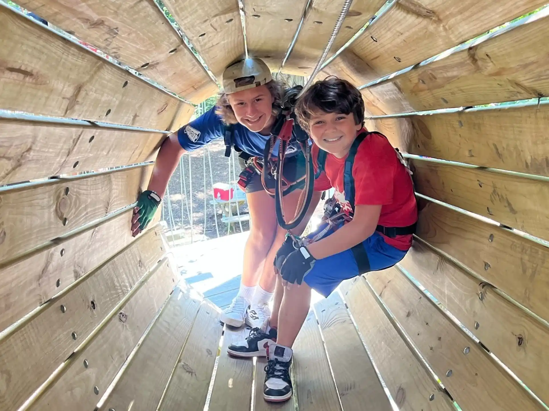 a couple of people on a rope bridge