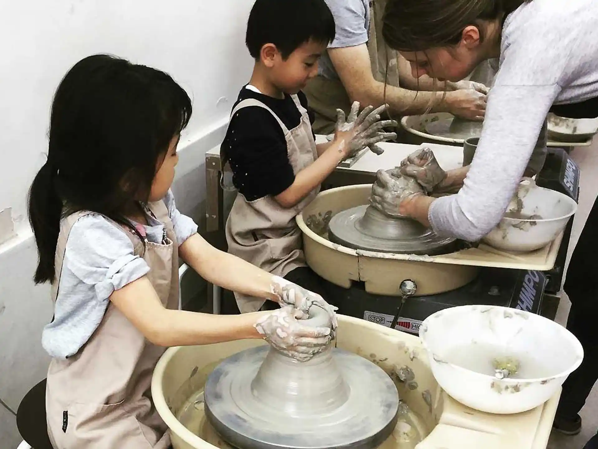 a person and a child working on a machine