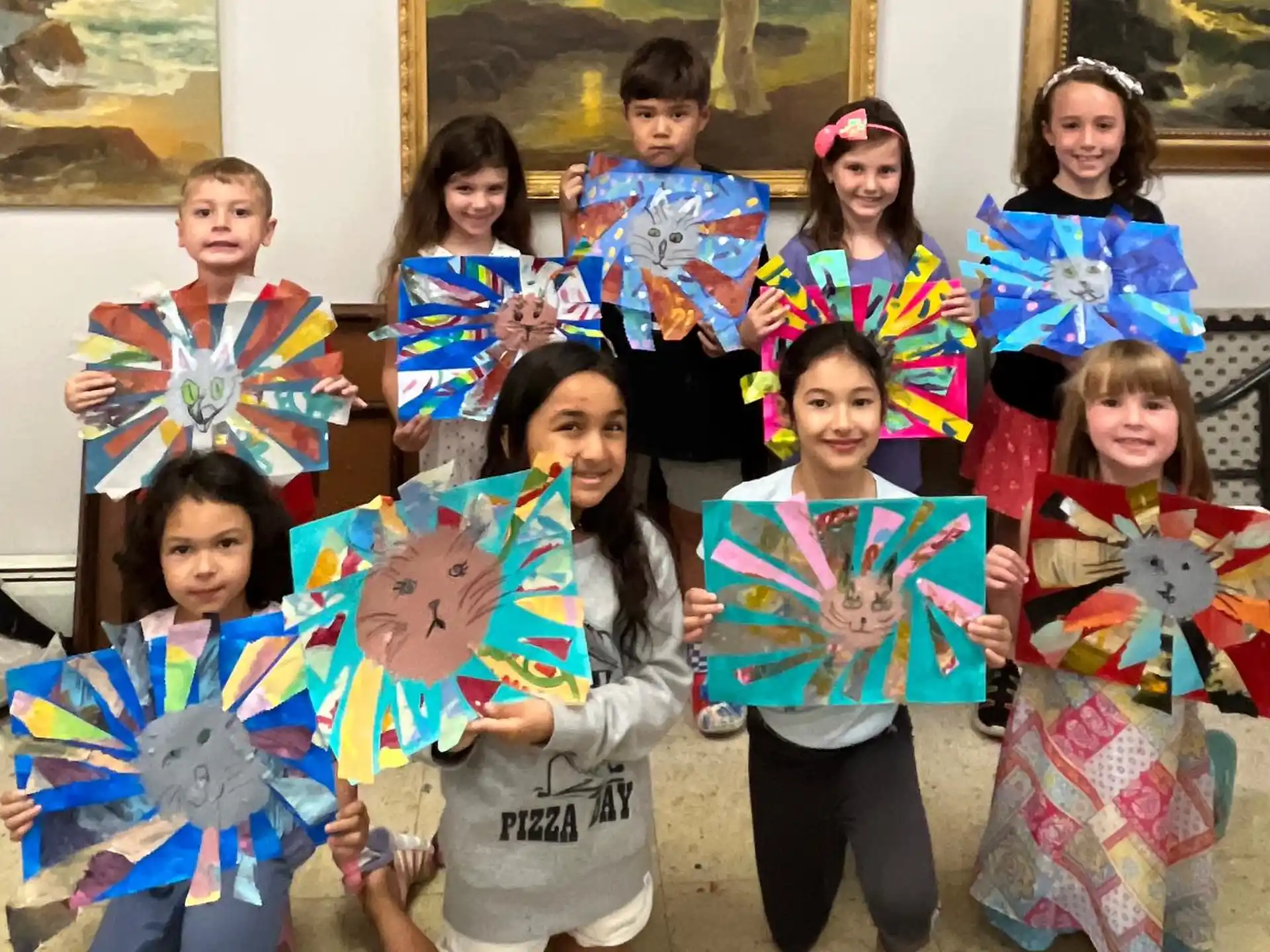 a group of children holding up kites
