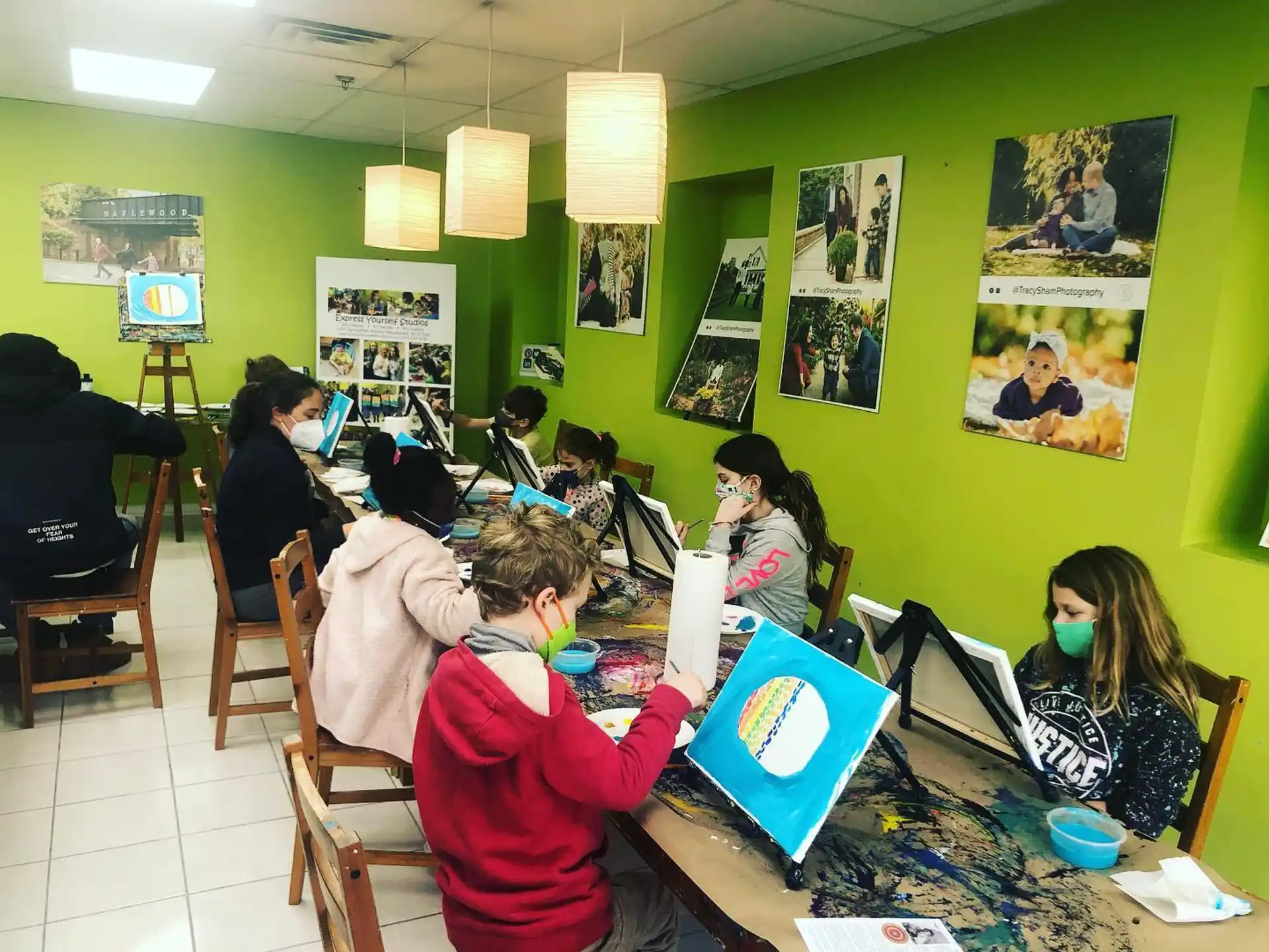 a group of people sitting at a table with posters on the wall