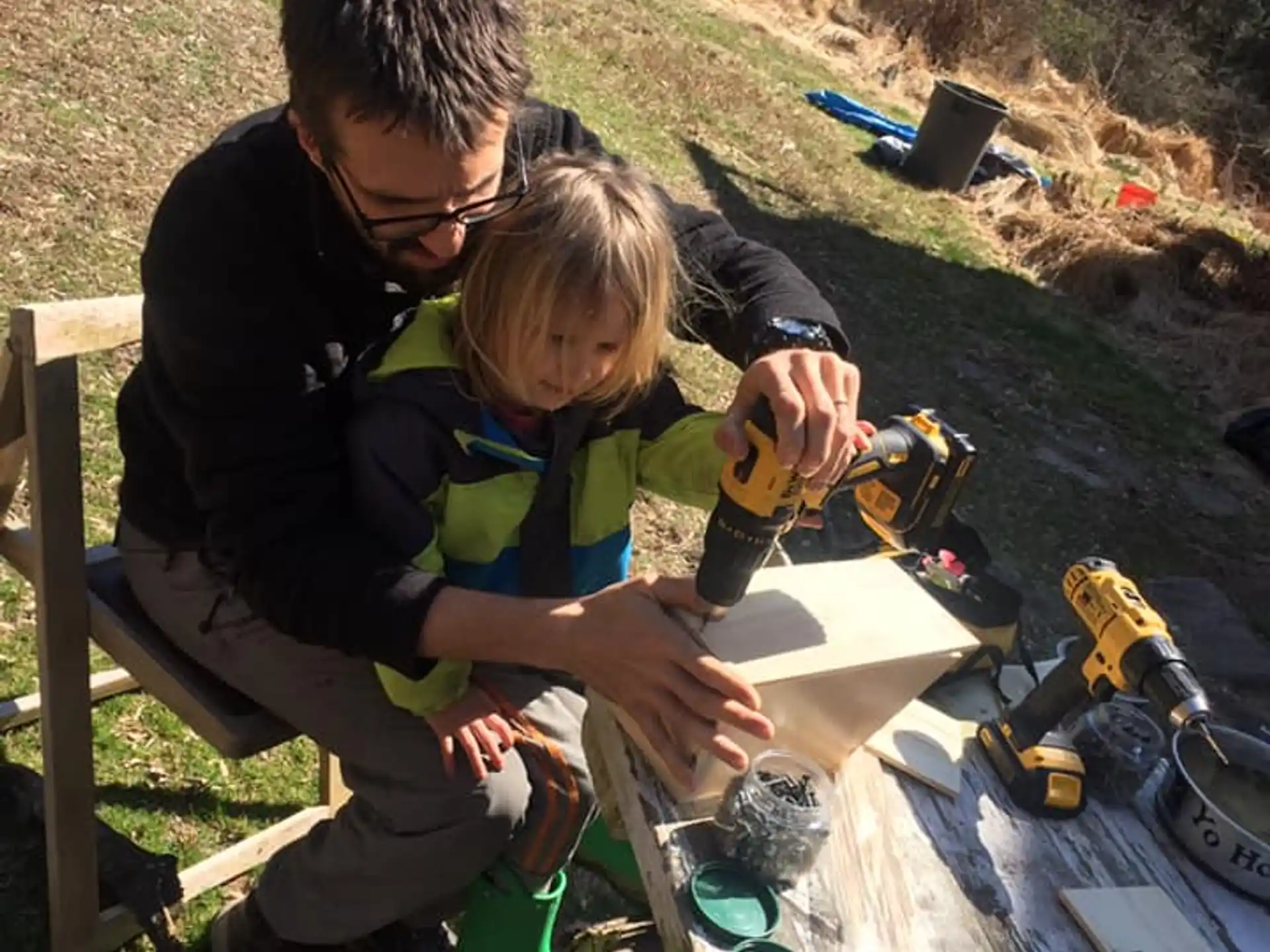 a person and a child working outside