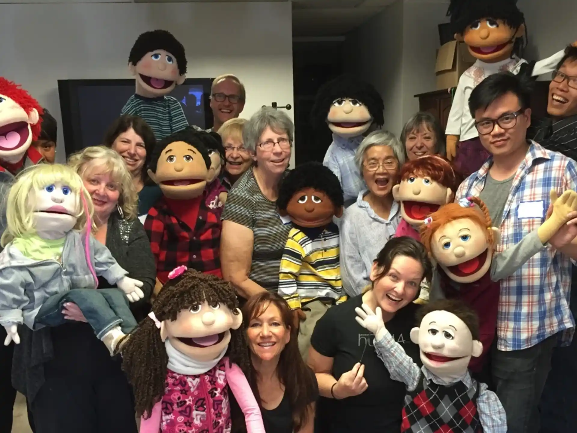 a group of people posing for a photo with stuffed animals