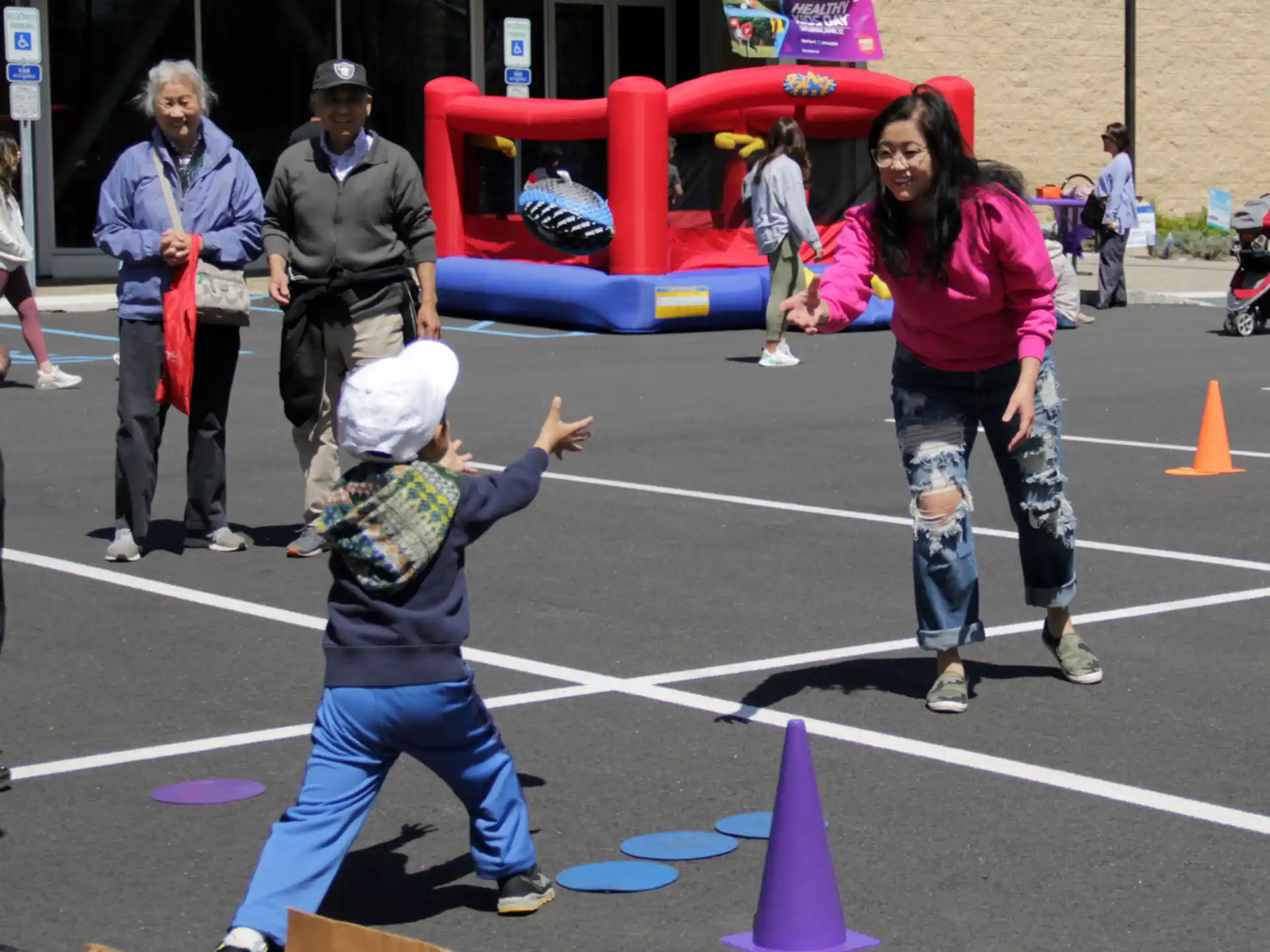 a person and a child playing in a parking lot