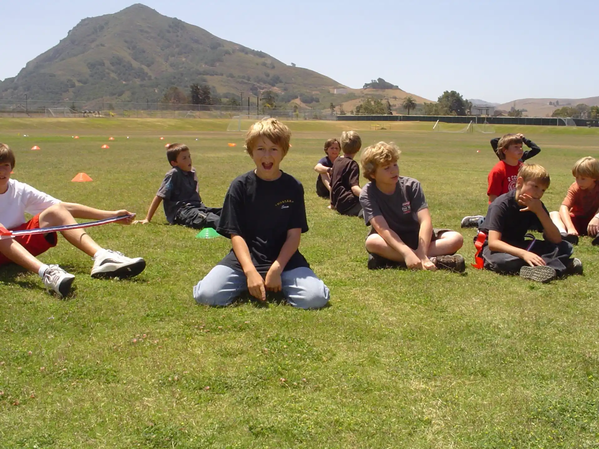 a group of people sitting on the grass