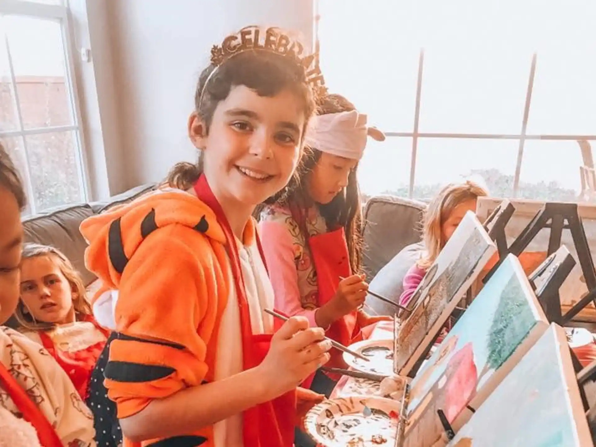 a group of children in orange uniforms