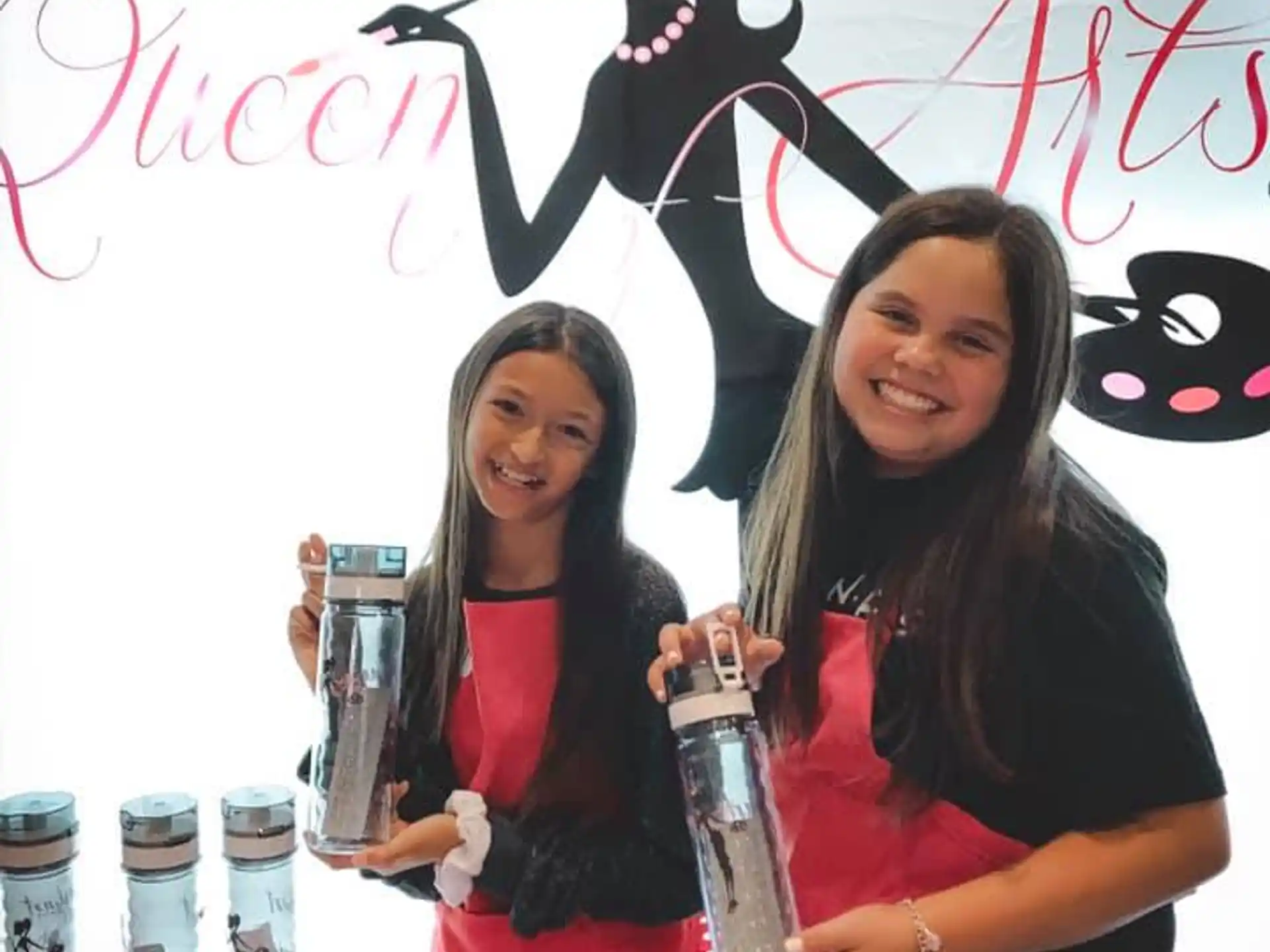 two women holding bottles