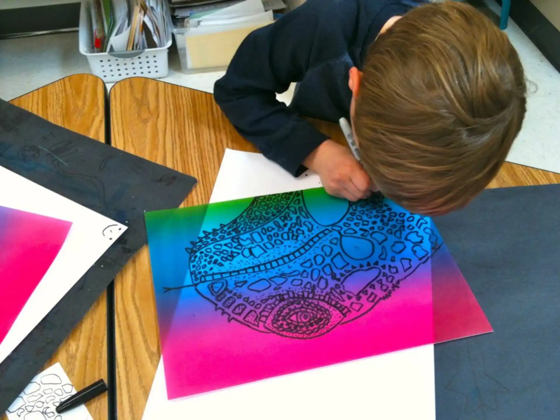 a child drawing on a piece of paper