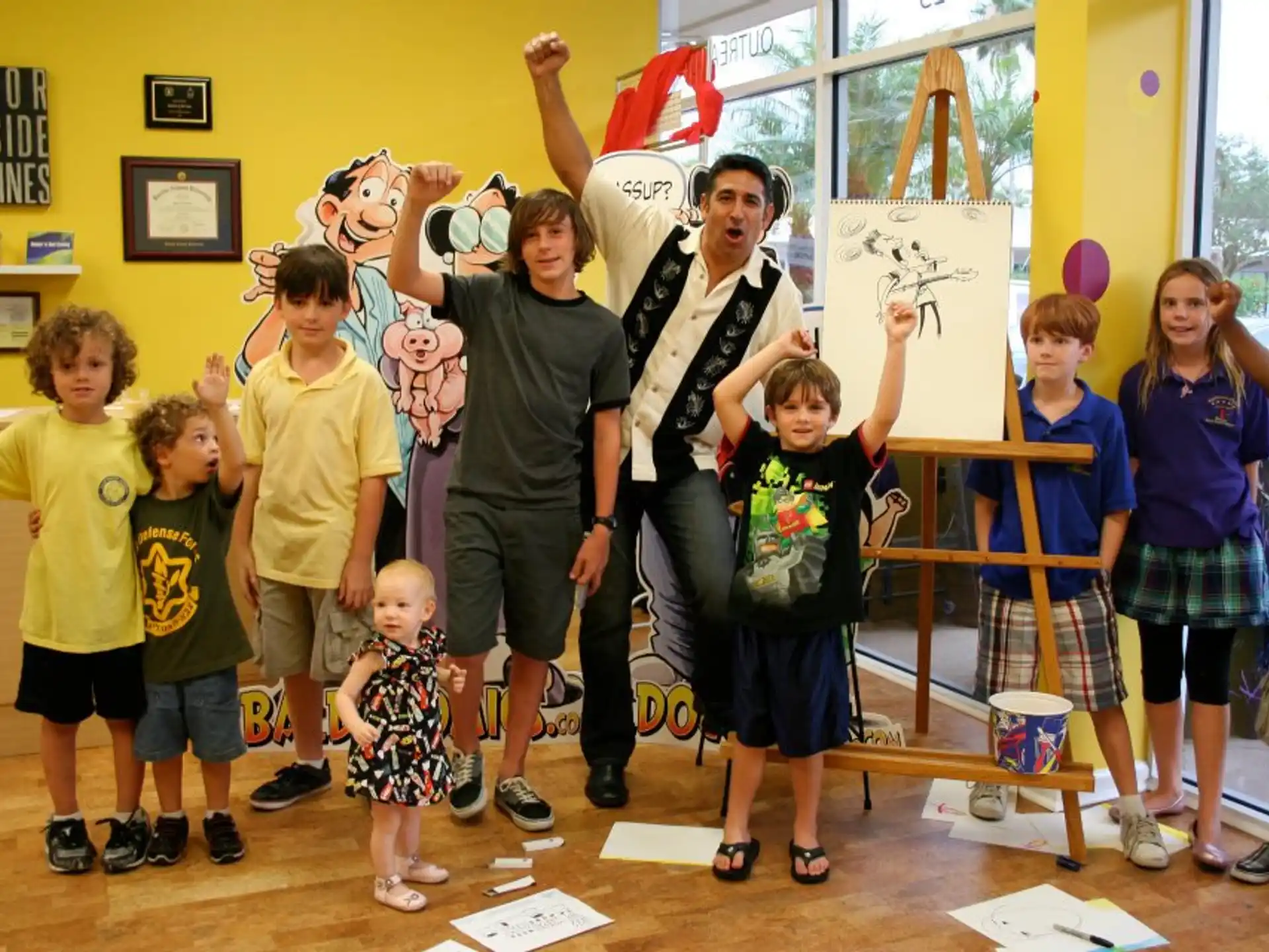 a group of children holding up a ribbon