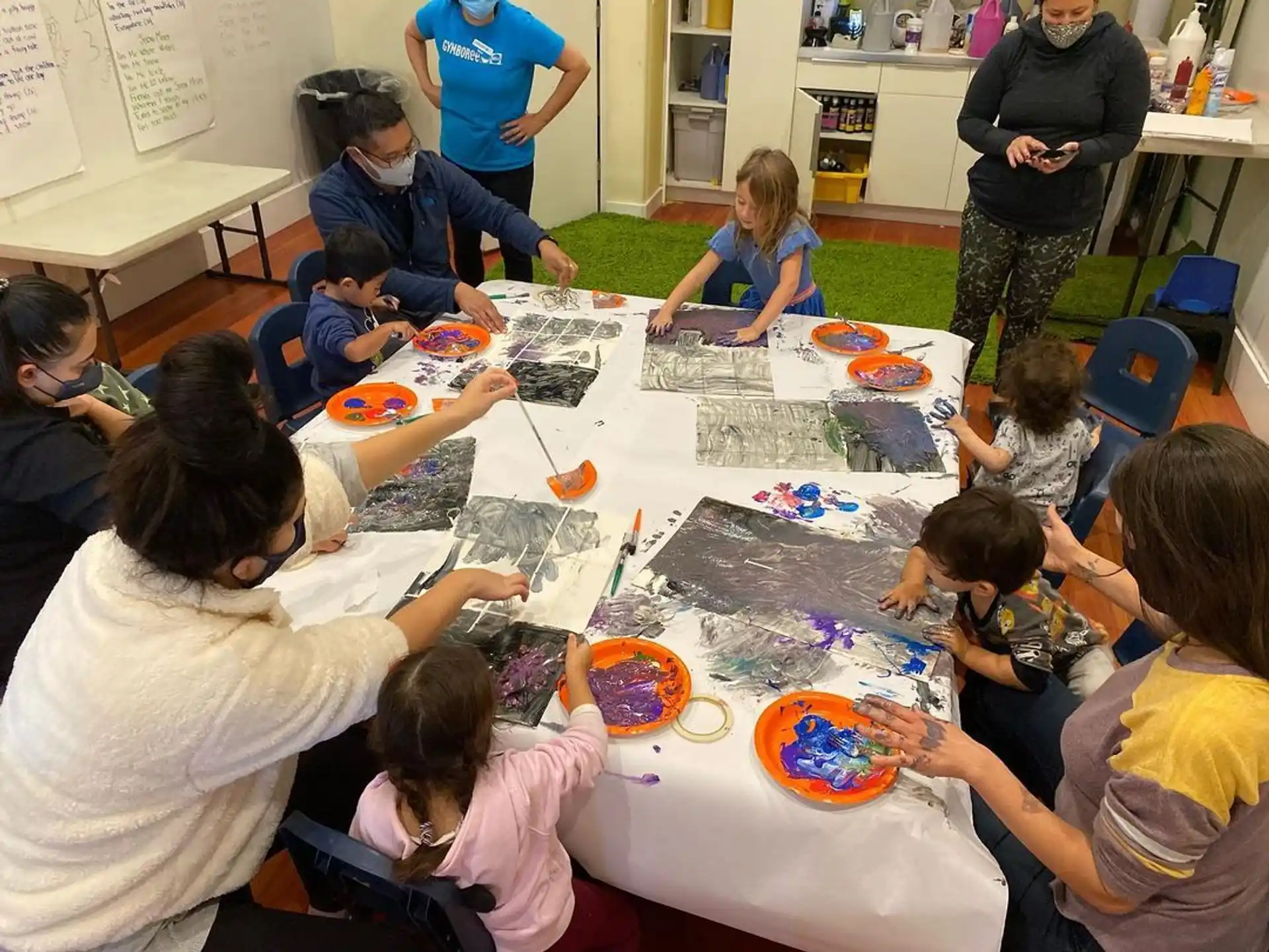 a group of people sitting around a table with plates on it