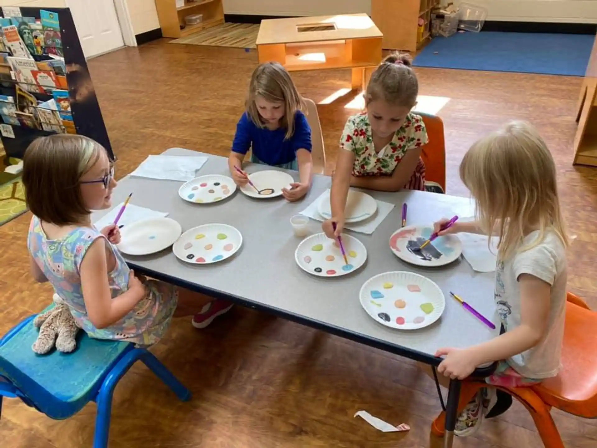 a group of children eating at a table