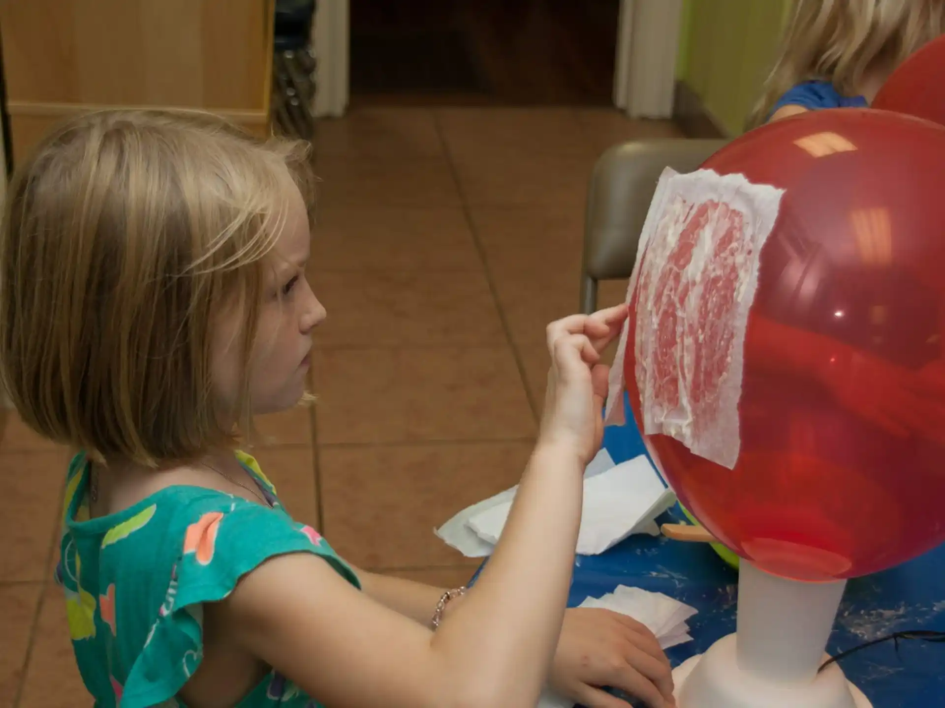 a child painting a pink vase