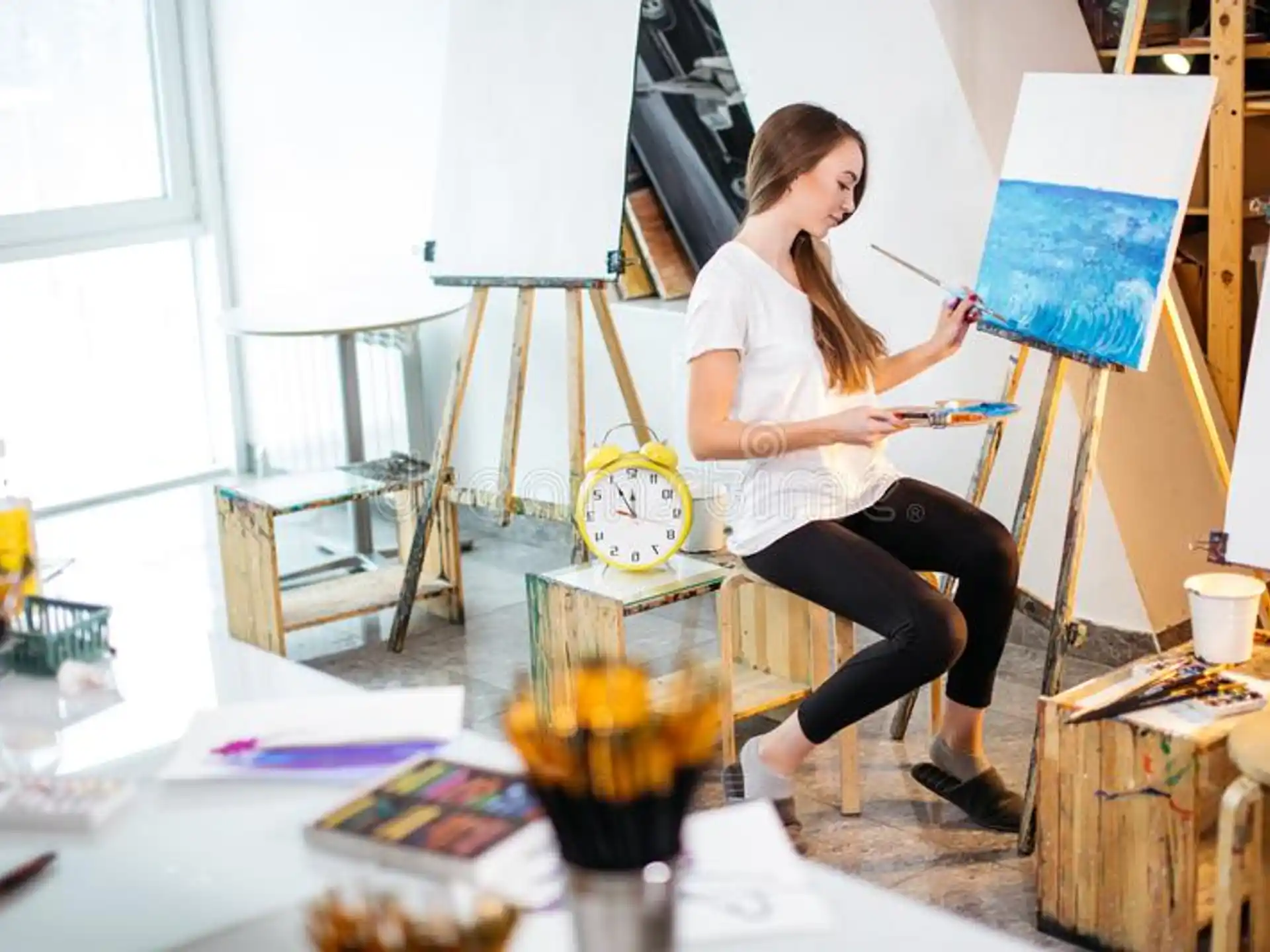 a person painting on a easel